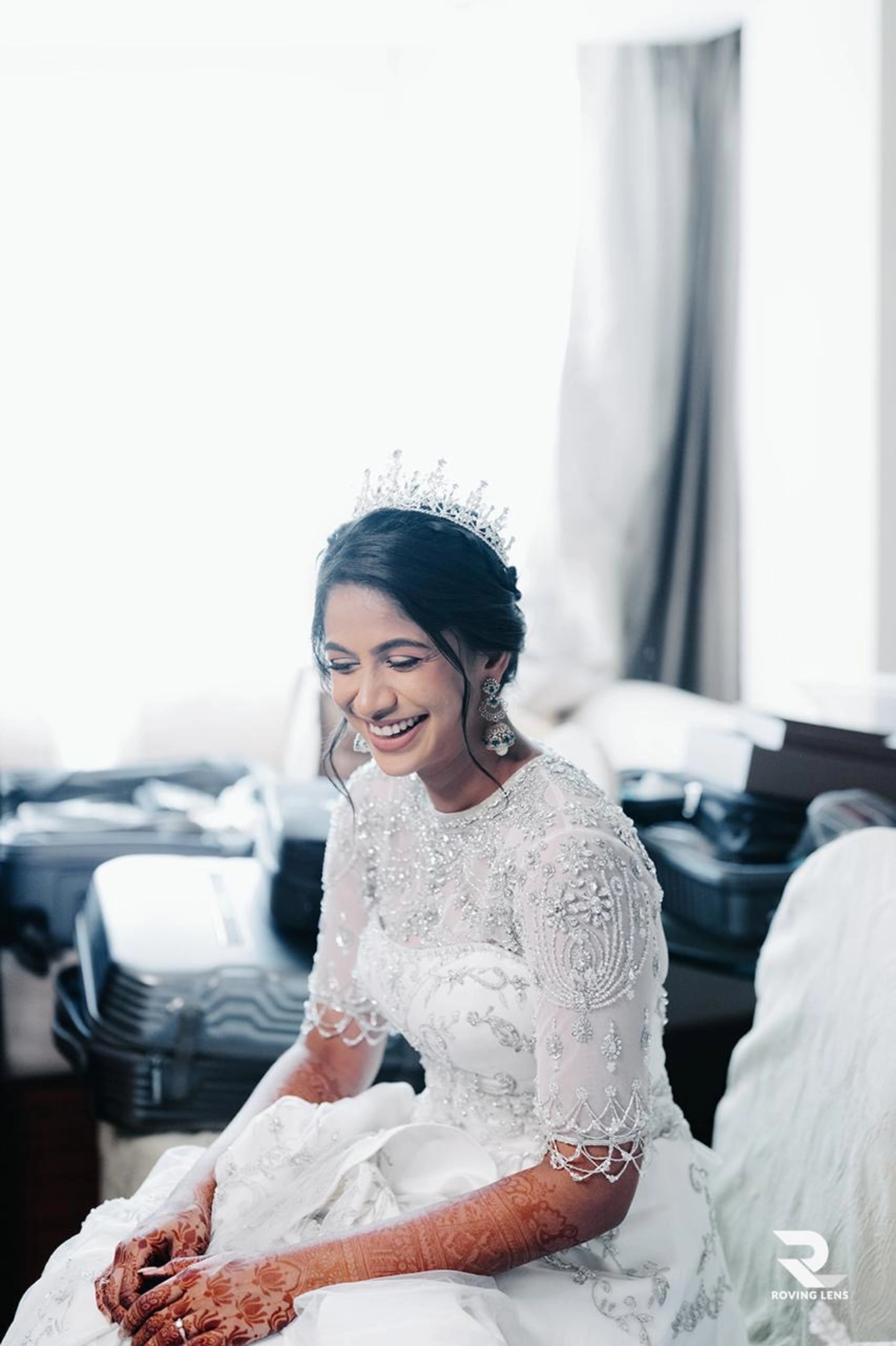 Bride Roushni smiling in a white gown for her church wedding by team Archana Karthick.