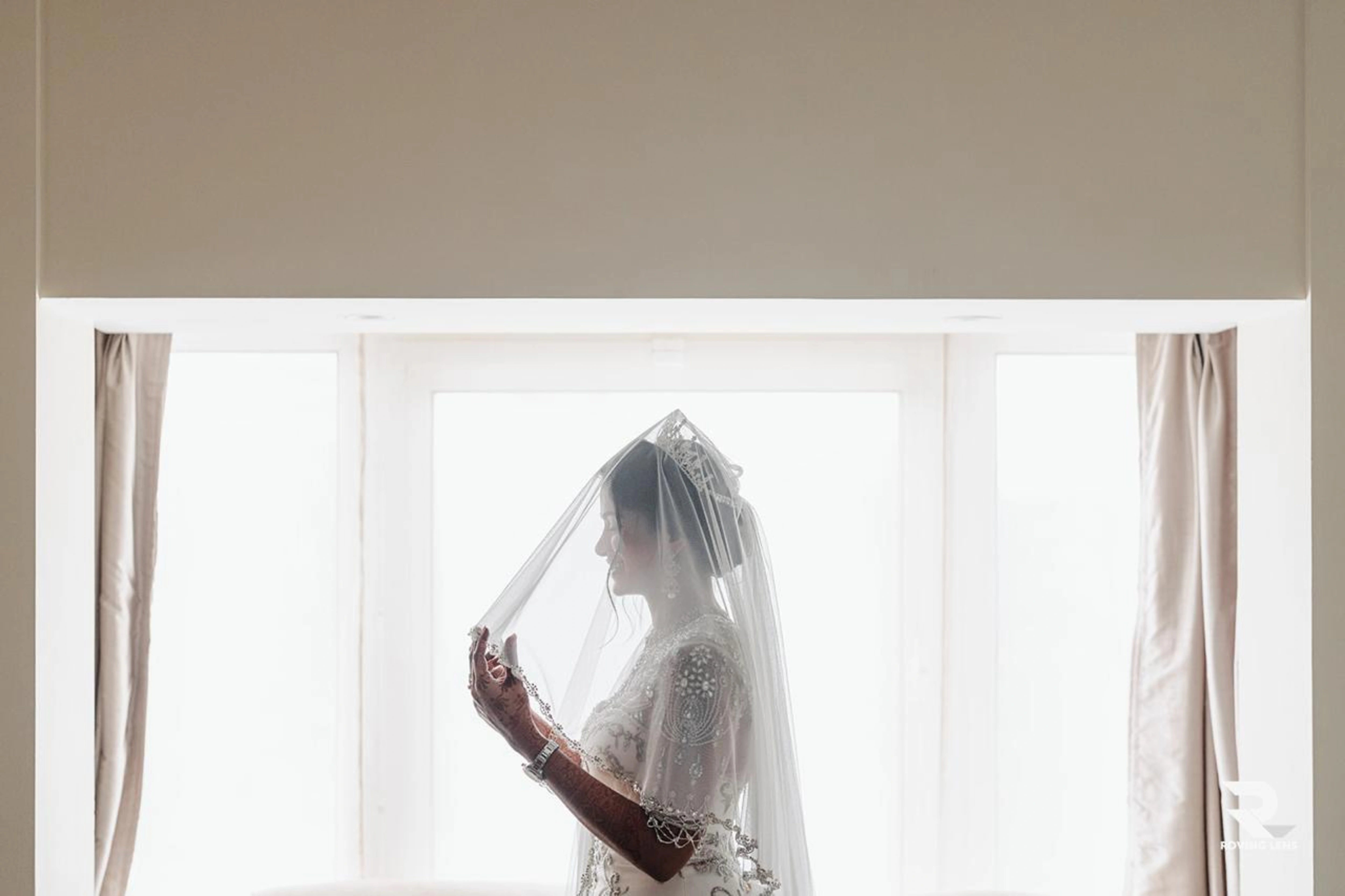 Bride Roushni smilng for shoot in a white gown for her church wedding by team Archana Karthick.