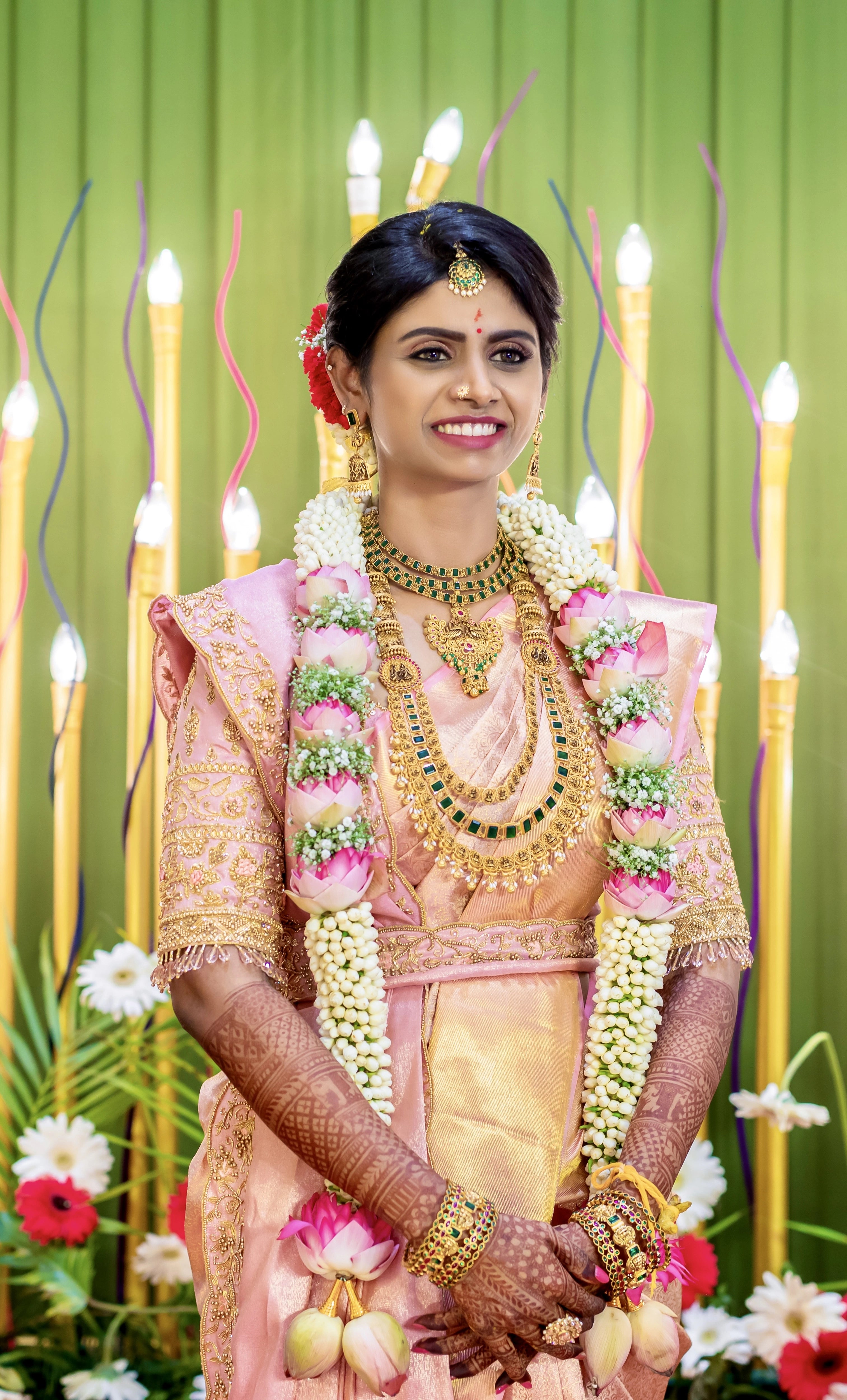 Bride Sahana in a peach cream silk blouse and belt, handcrafted intricately with beads, cutdana, zari, crystals and resham by team Archana Karthick.