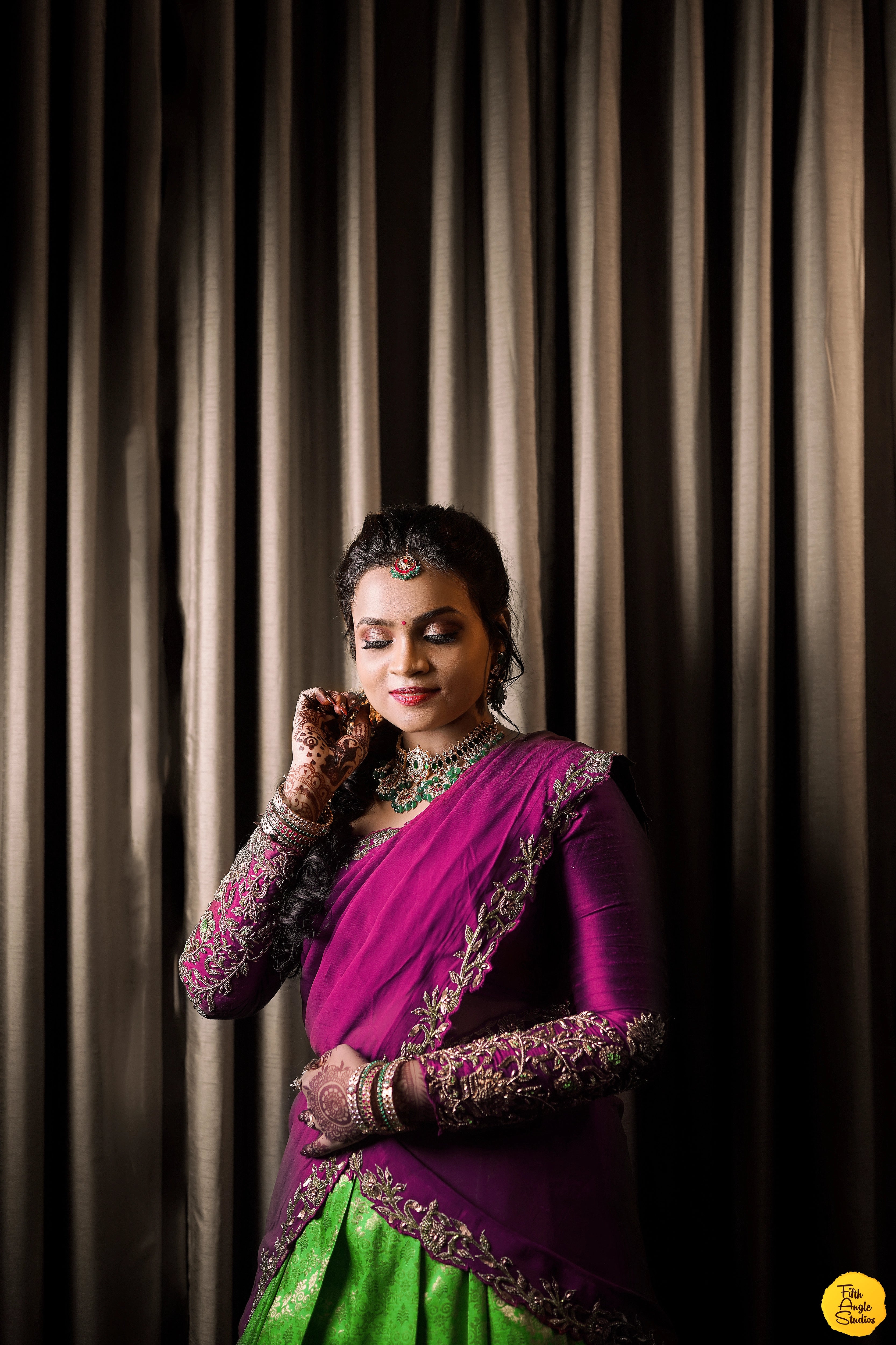 Bride Sai Sridevi in a magenta and green half saree, handcrafted by team Archana Karthick.