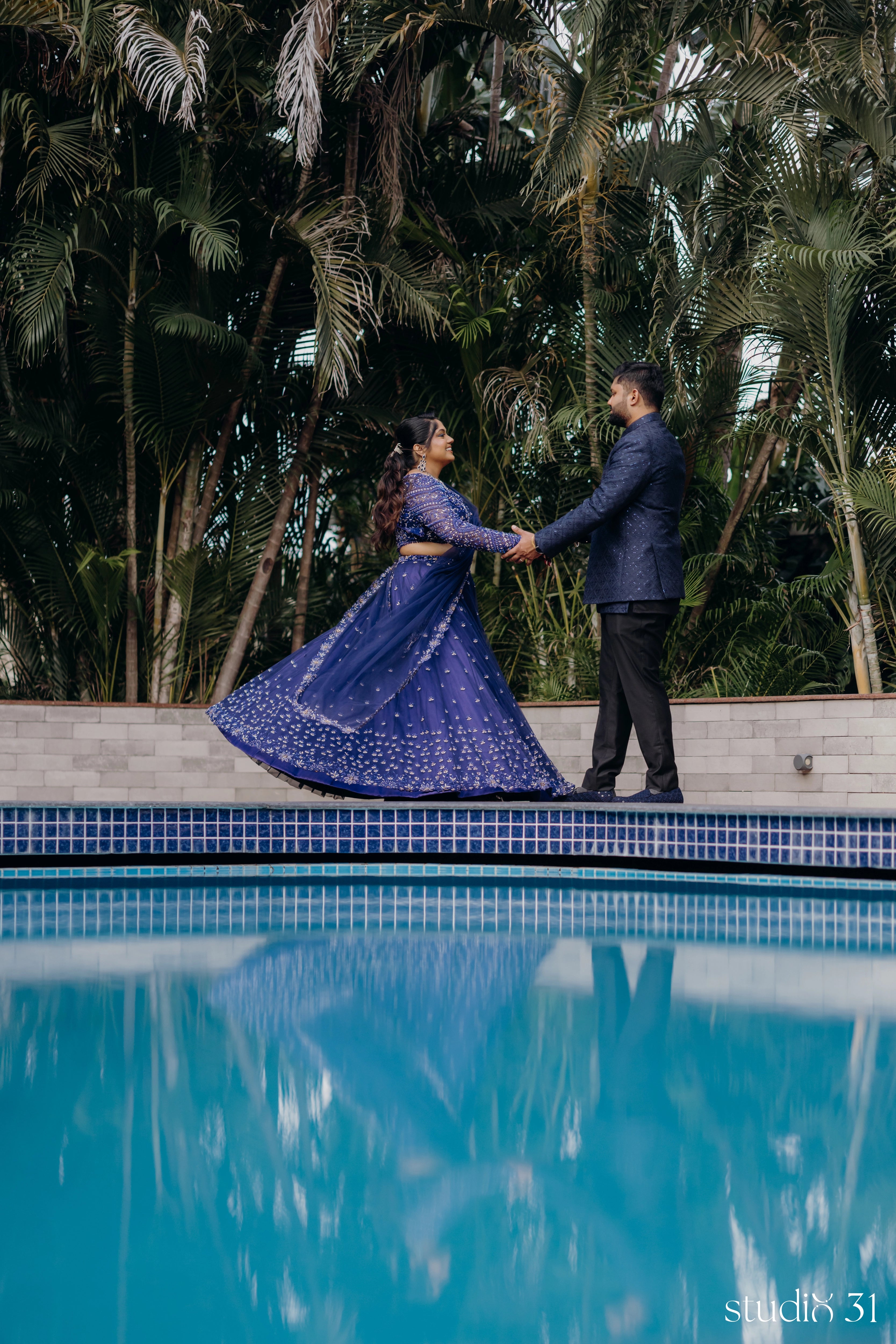 Bride Sambavi from Singapore twirling in a midnight blue lehenga by Archana Karthick