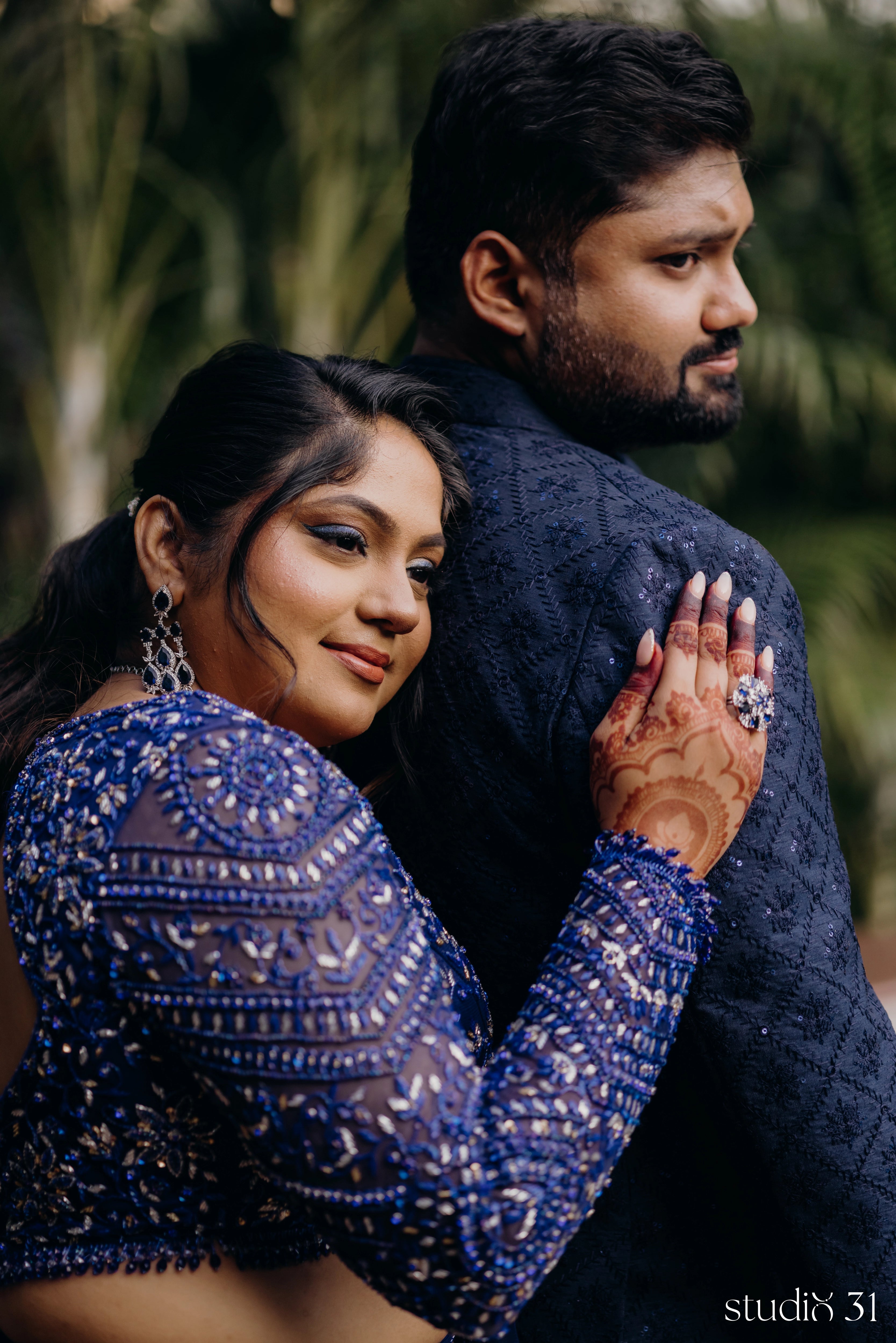 Bride Sambavi from Singapore with groom in a midnight blue lehenga by Archana Karthick