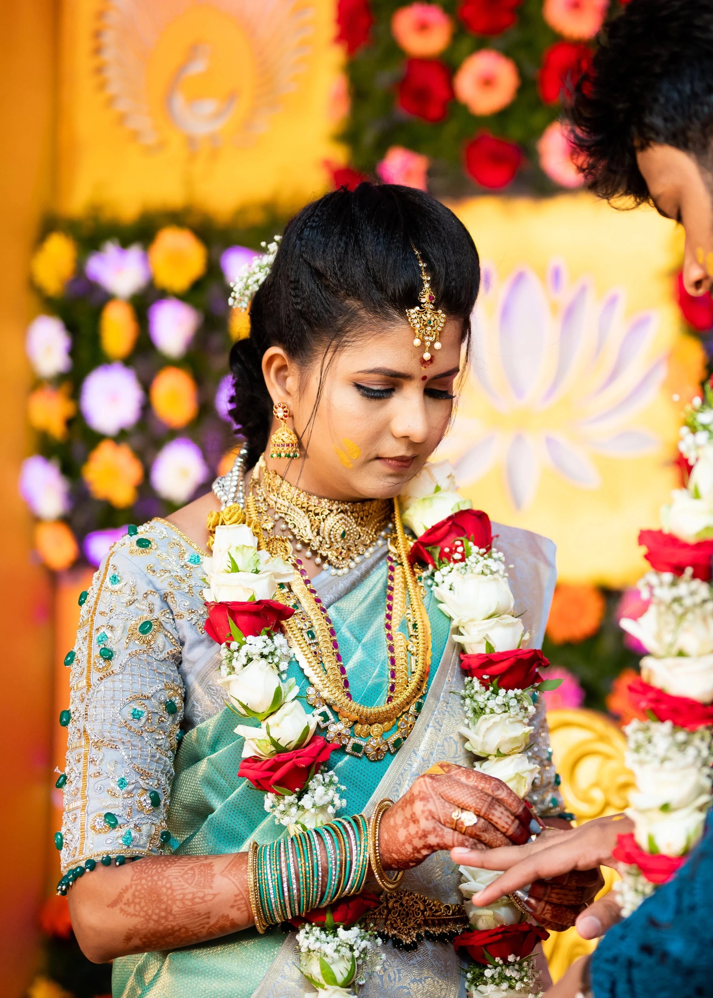 Bride Sarumathi exchanging rings in a powder blue silk blouse, intricately handcrafted with zardozi, resham, stones and cutdana by team Archana Karthick.
