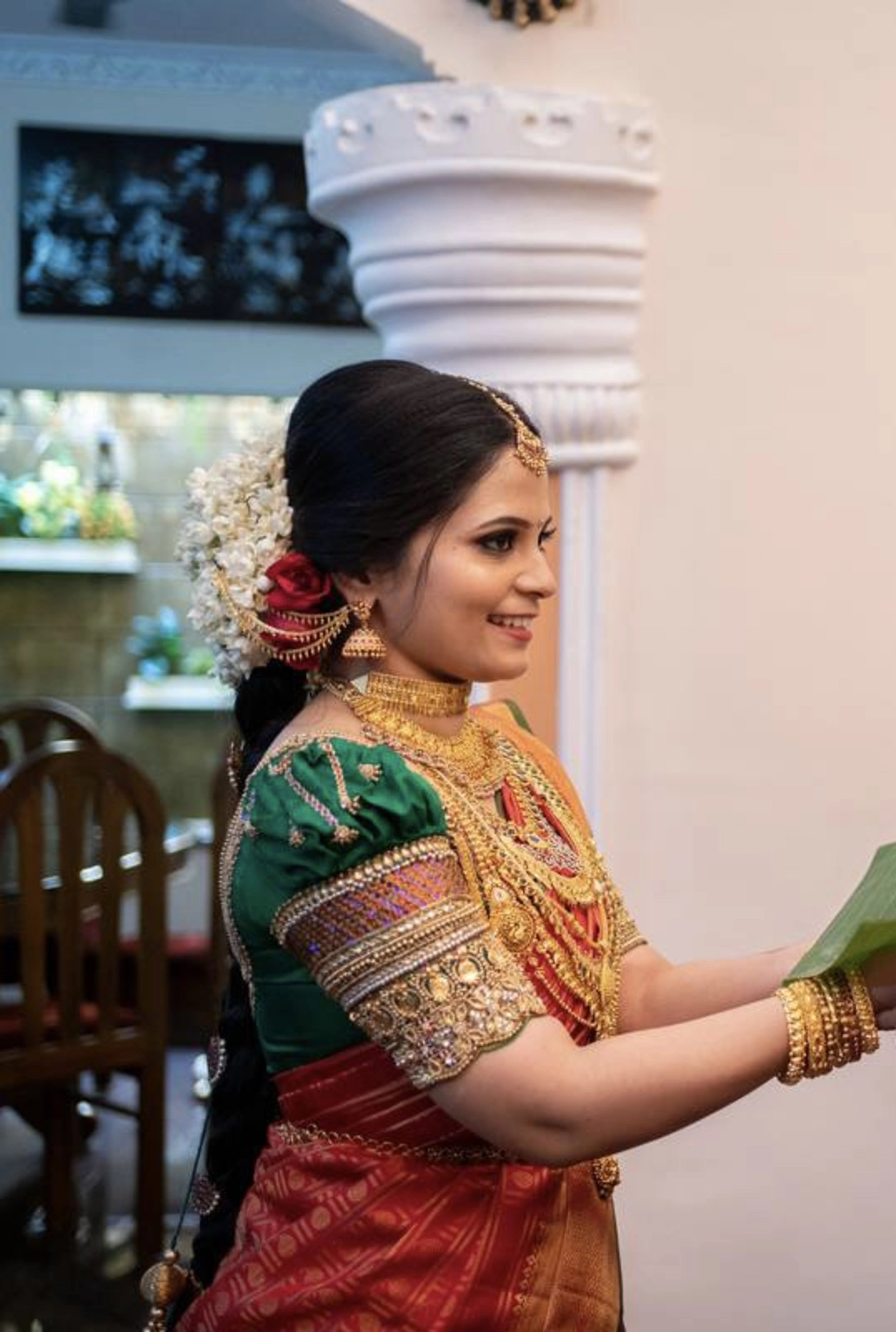 Bride Shalini from Kerala in a green silk blouse embellished by team Archana Karthick.
