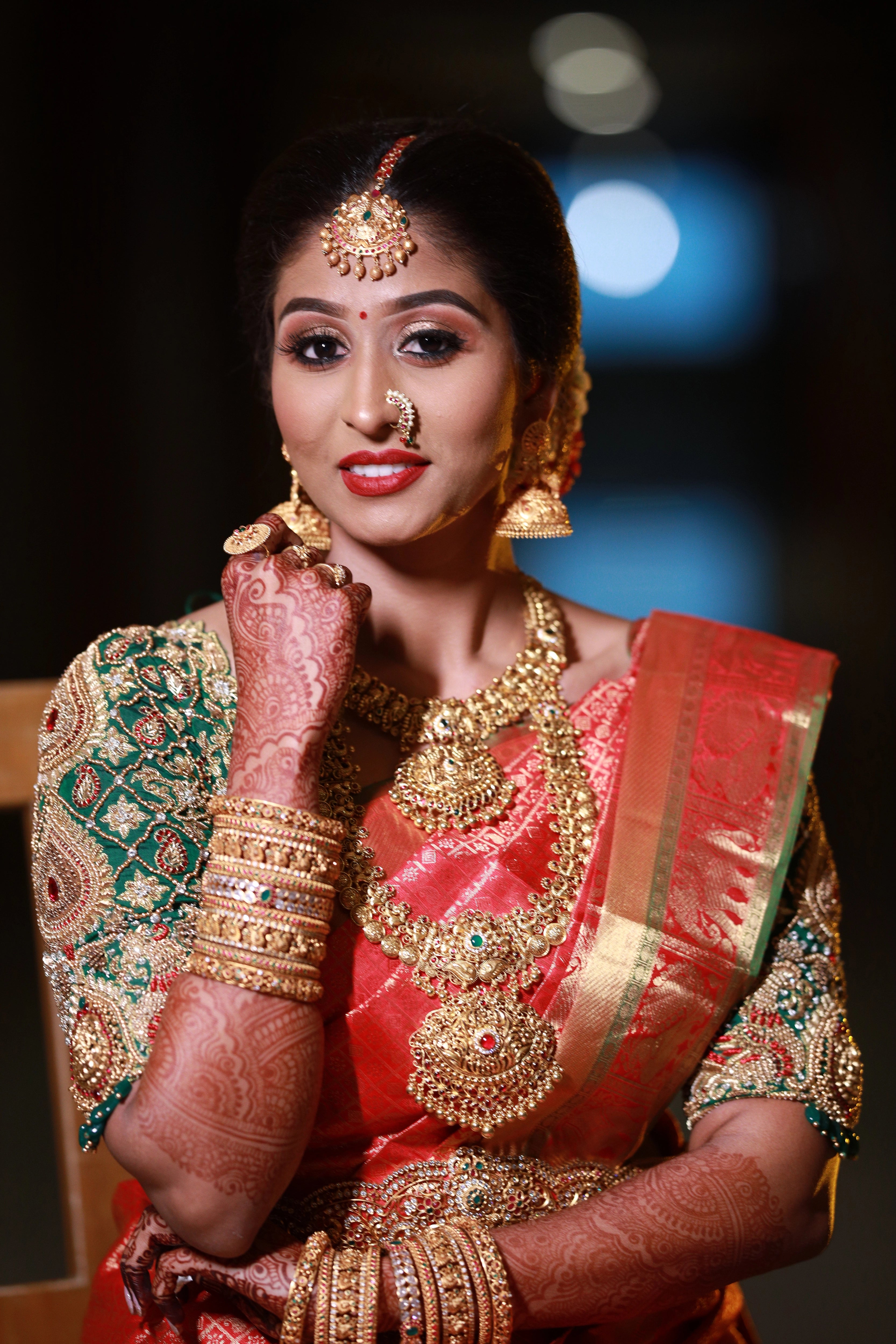 Bride Shanmuga Priya in a bottle green silk blouse for her wedding, handcrafted with beads, zardozi, kundan and crystals by team Archana Karthick.