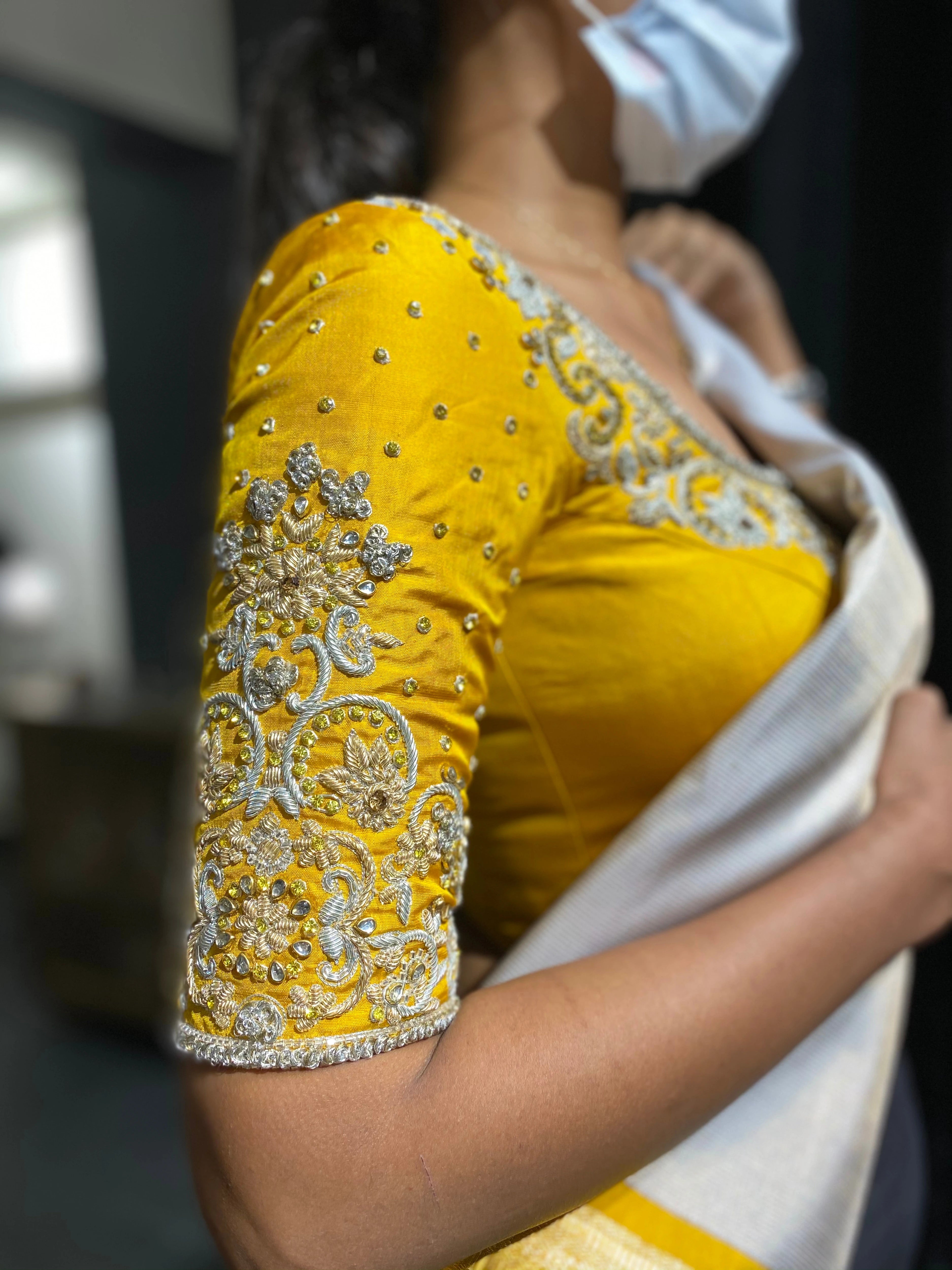 Bride Shanmugapriya for her engagement in a yellow silk blouse by team Archana Karthick.
