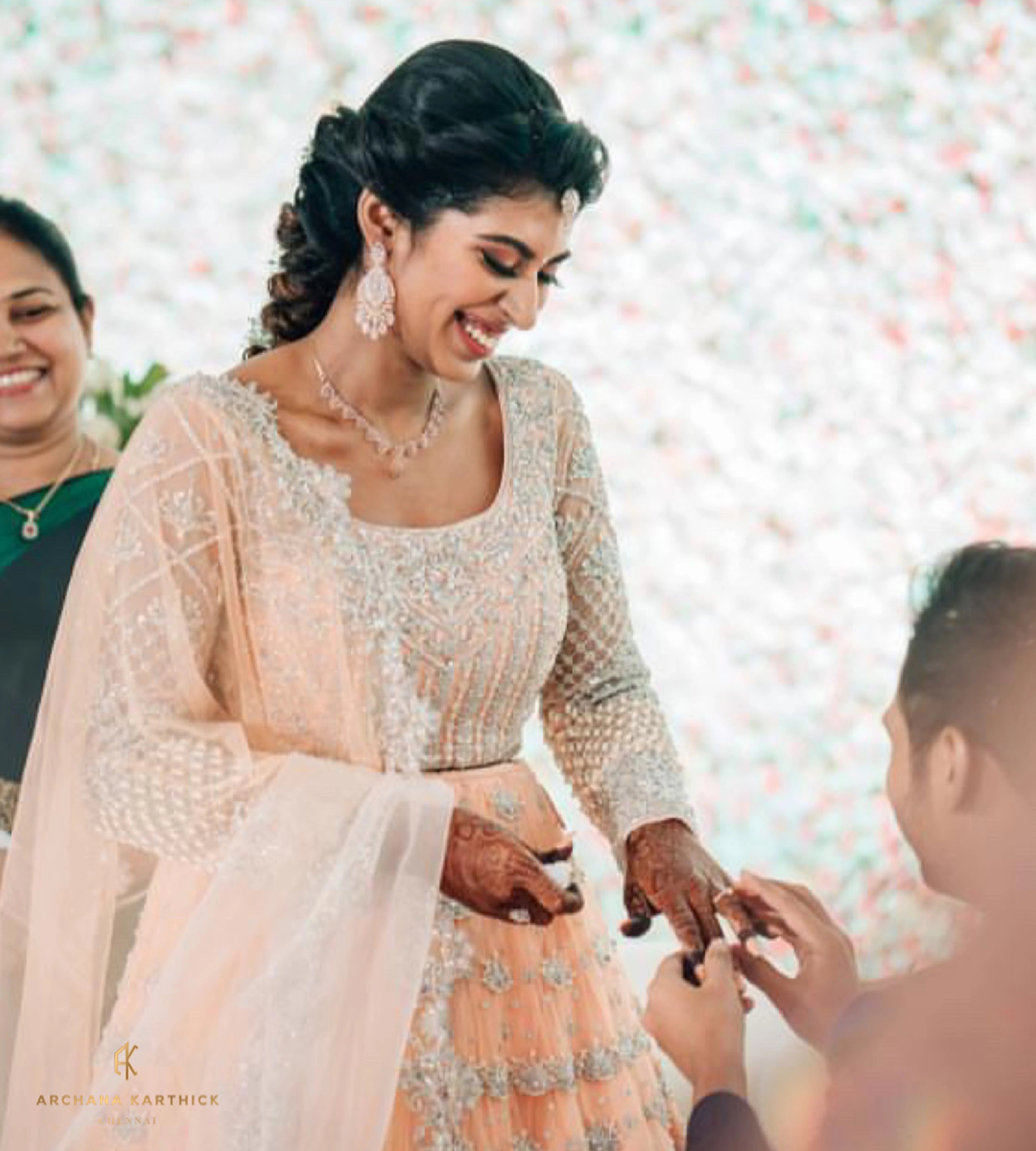 Bride Shanmugapriya in a peach tulle reception lehenga, handcrafted by team Archana Karthick.