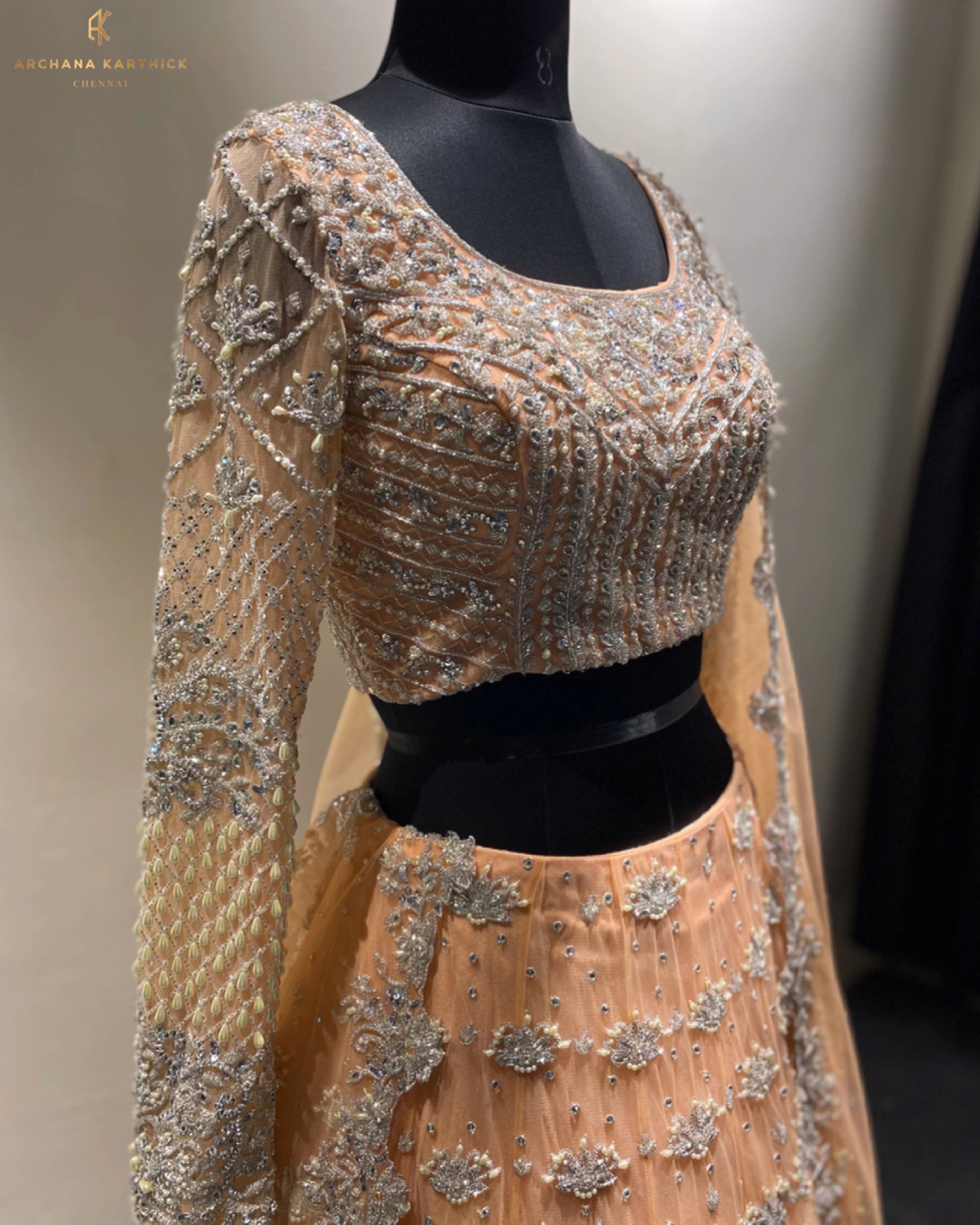 Bride Shanmugapriya's peach tulle reception lehenga at the studio, handcrafted by team Archana Karthick.