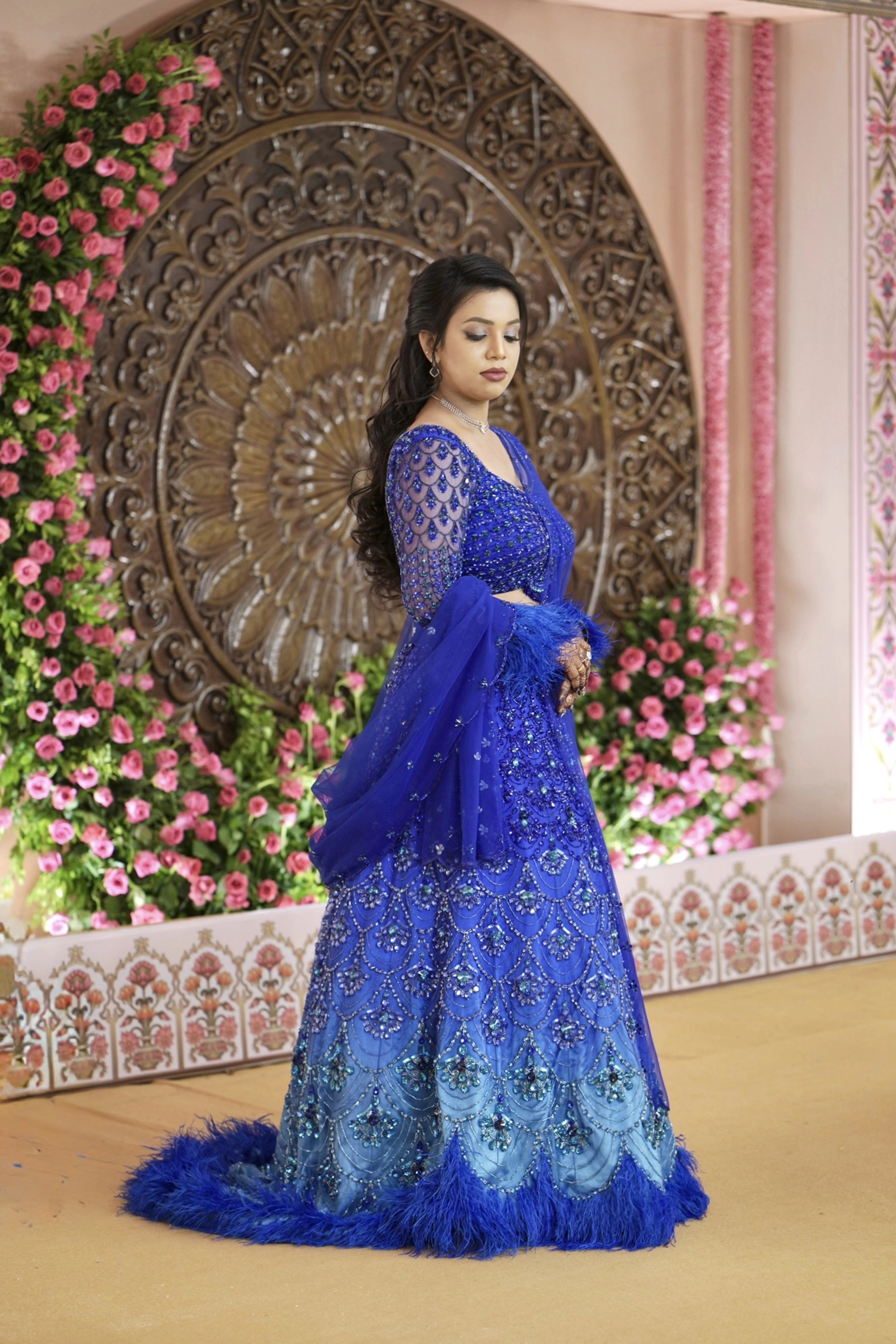 Bride Sharon in a peacock themed blue lehenga by Archana Karthick