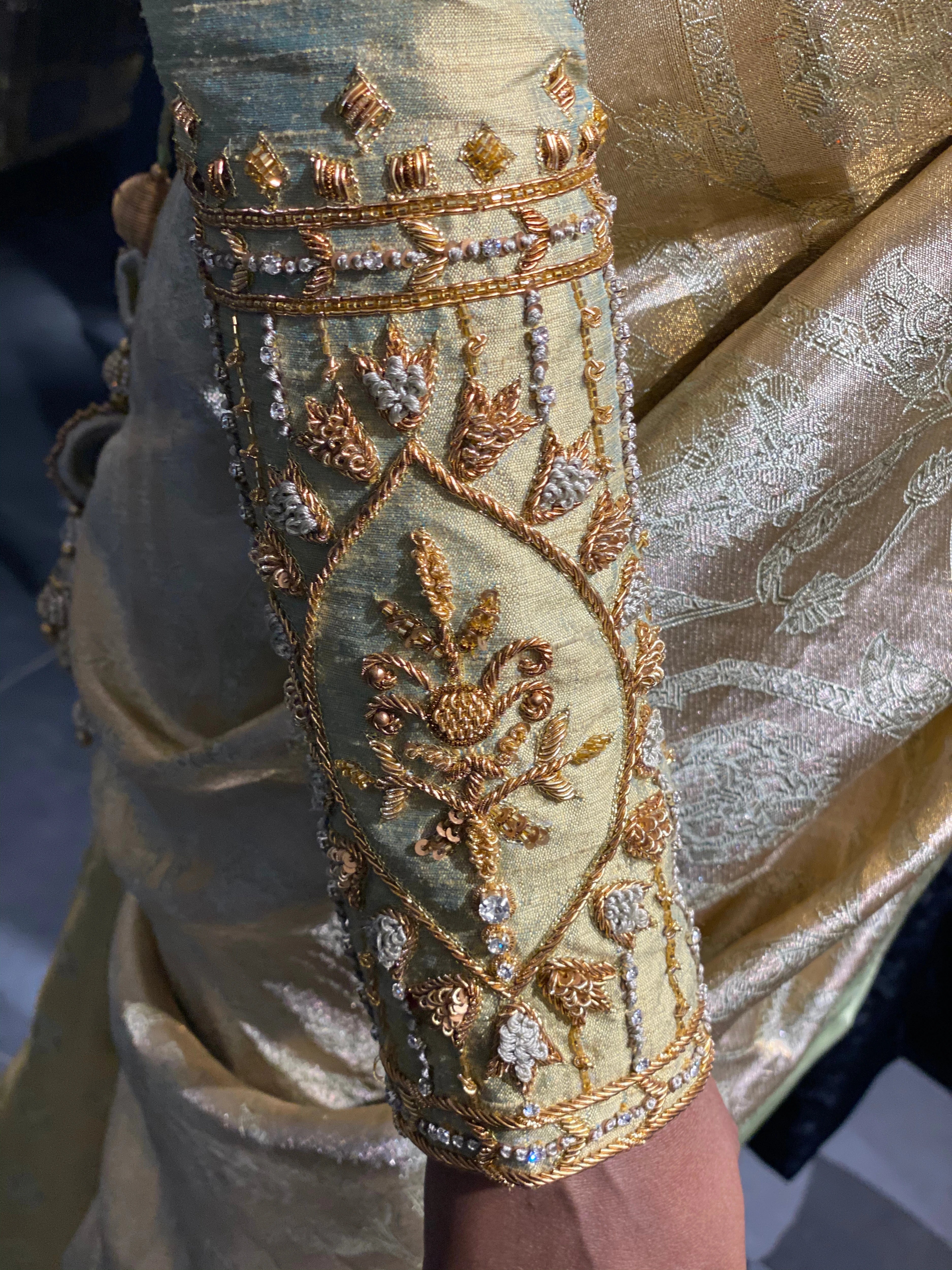 Bride Sherin during her fittings in an olive green silk blouse, handcrafted by team Archana Karthick.