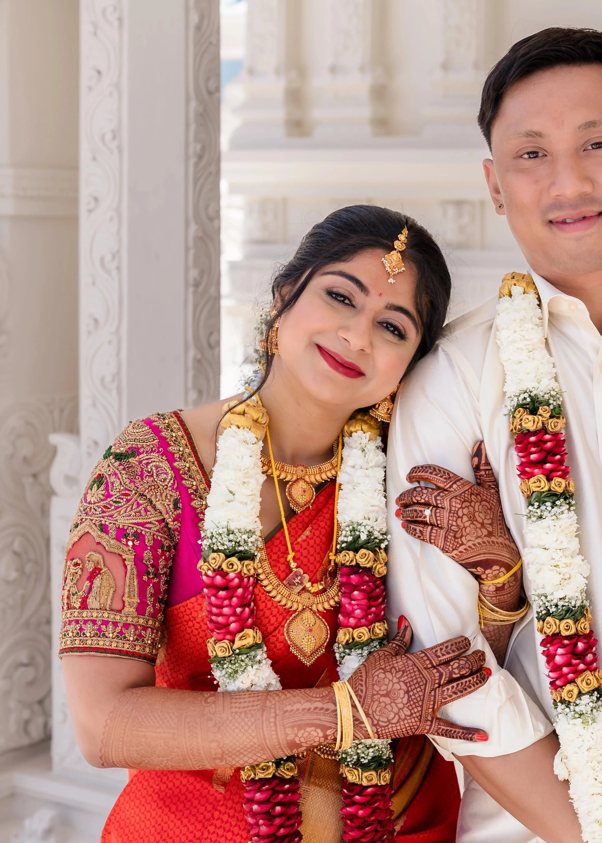 Bride Shivani in a magenta silk blouse, intricately handcrafted with beads, stones, resham, mirrors, jhumkas and zardozi by team Archana Karthick.