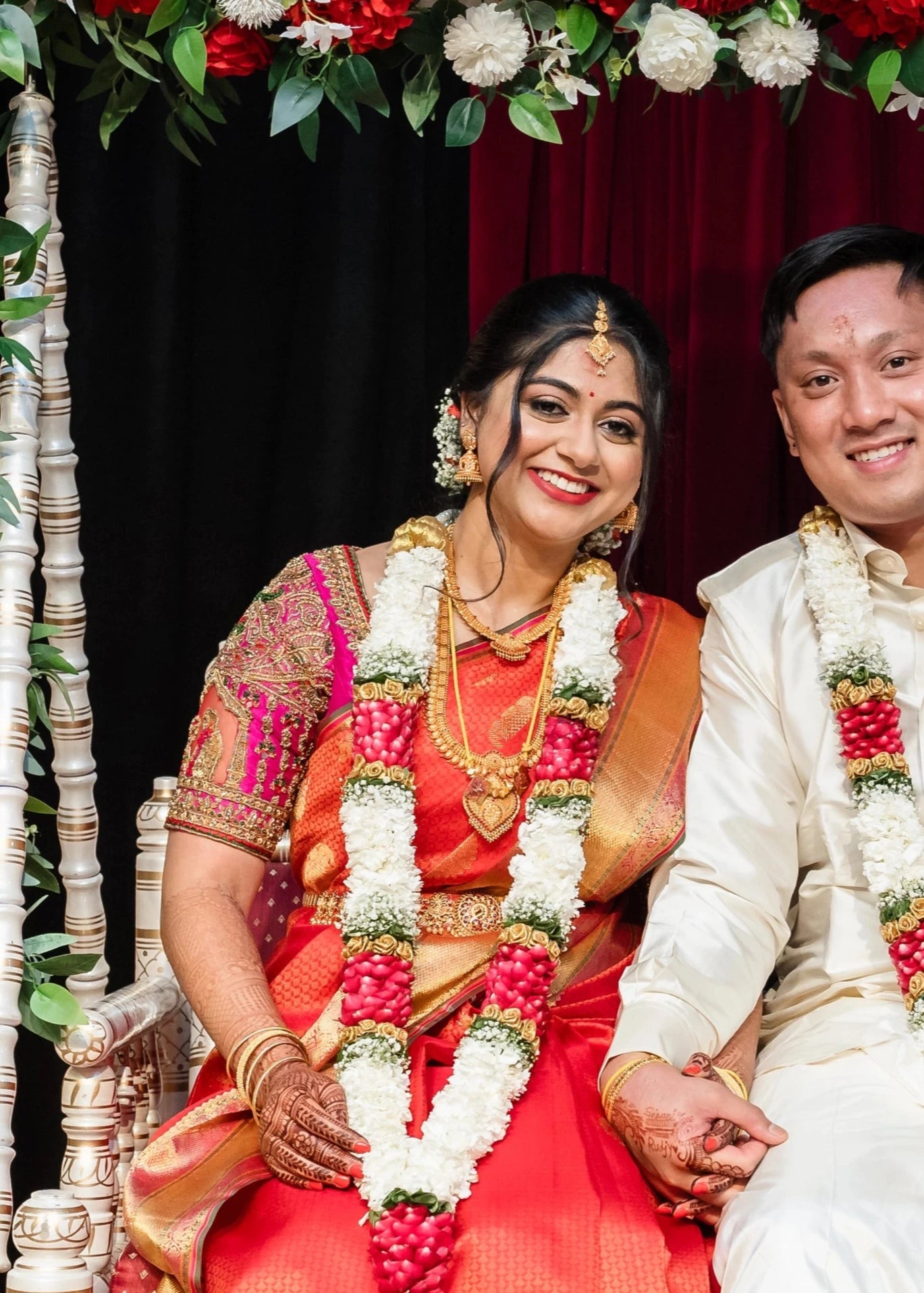 Bride Shivani posing on a swing in a magenta silk blouse, intricately handcrafted with beads, stones, resham, mirrors, jhumkas and zardozi by team Archana Karthick.