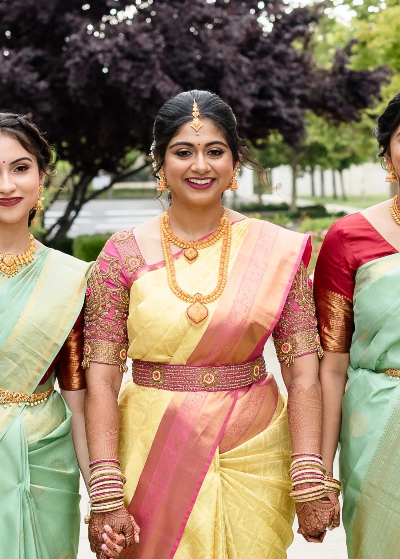 Bride Shivani with bridesmaids in a pink silk blouse & belt, intricately handcrafted with beads, stones, resham, sequins and zardozi by team Archana Karthick.