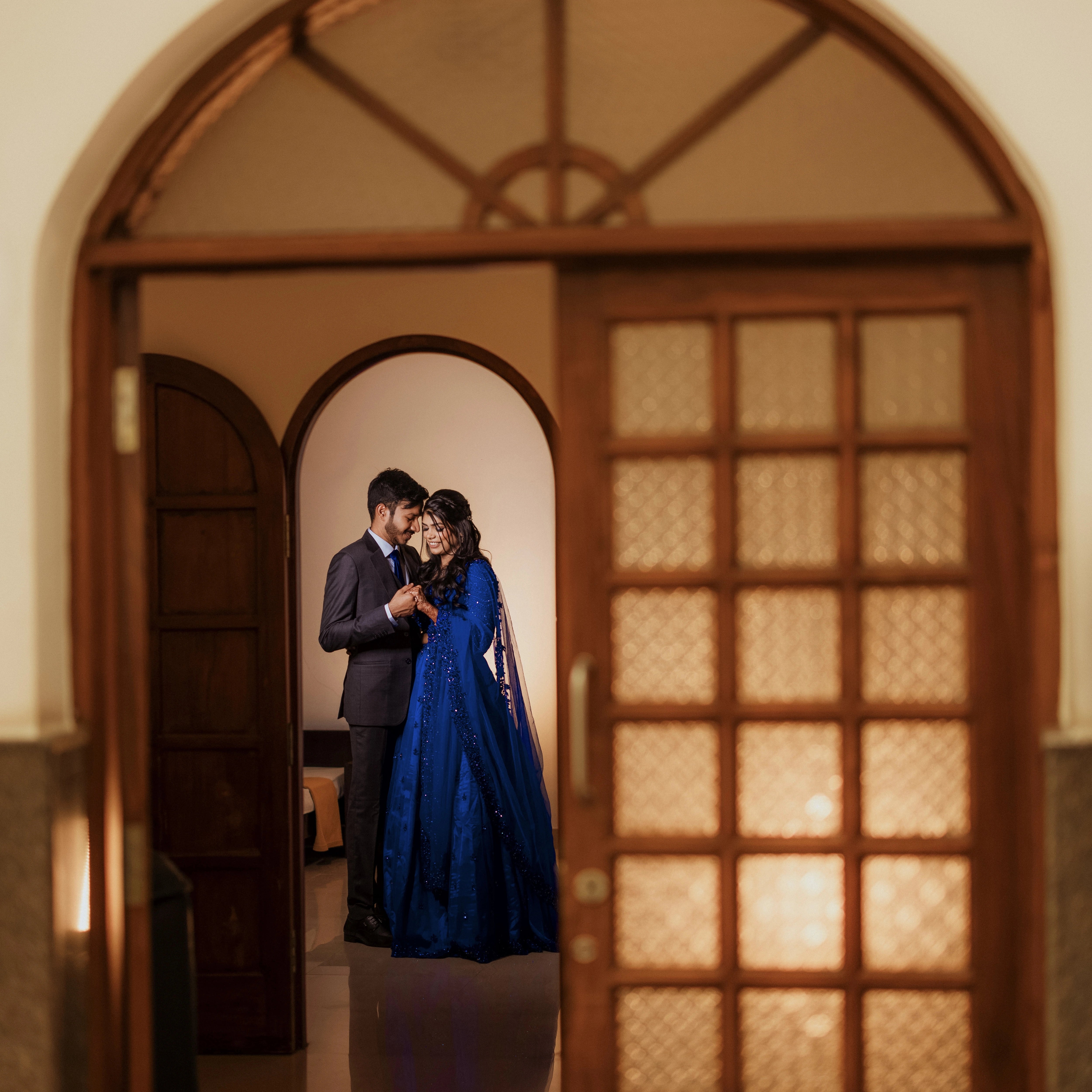Bride Snegha from Australia posing for photoshoot in a blue tulle lehenga, handcrafted with sequins, cutdana, rhinestones and crystals by team Archana Karthick.