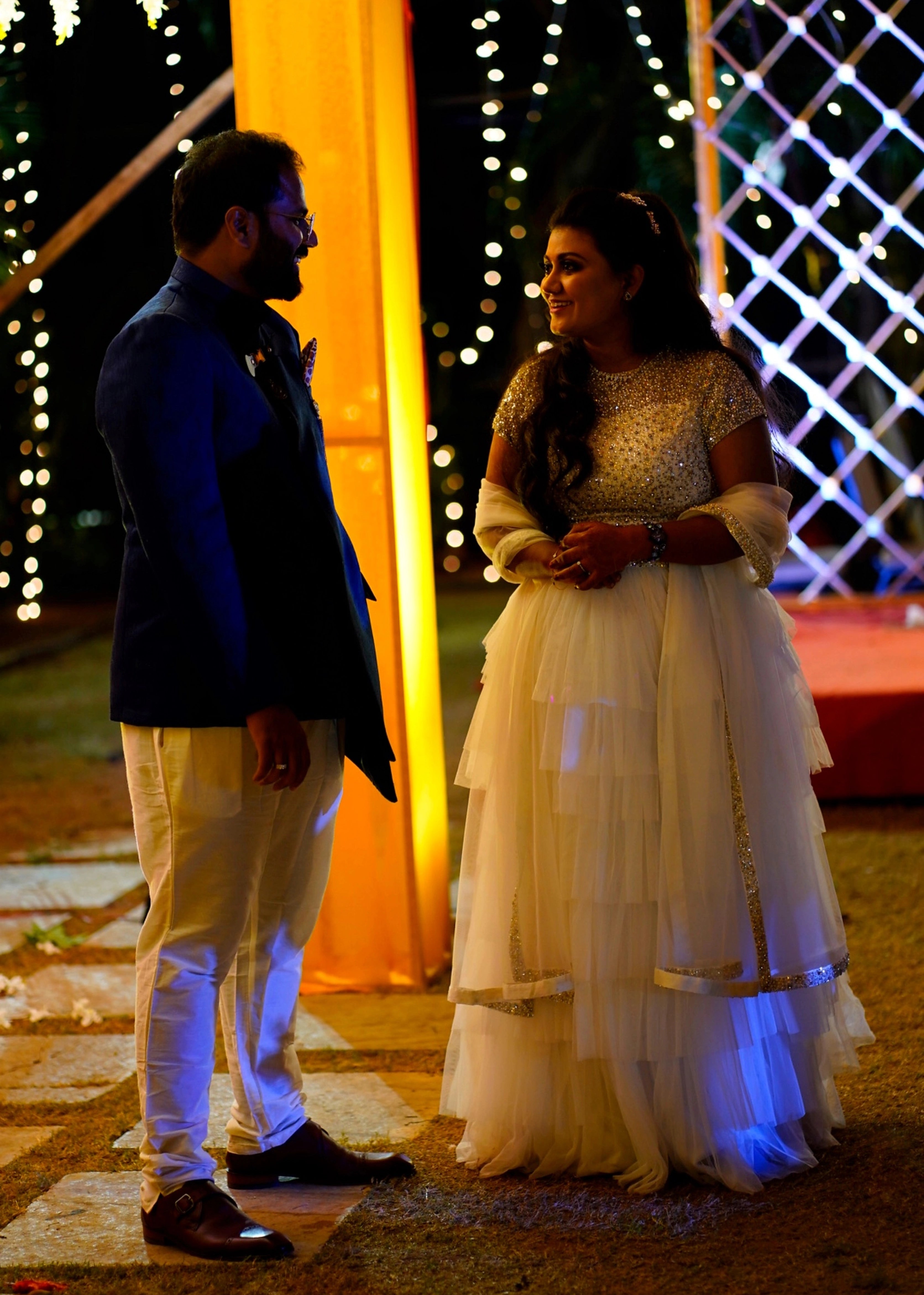 Bride Sowmya Rani from Hyderabad smiling in a white lehenga handcrafted by team Archana Karthick.