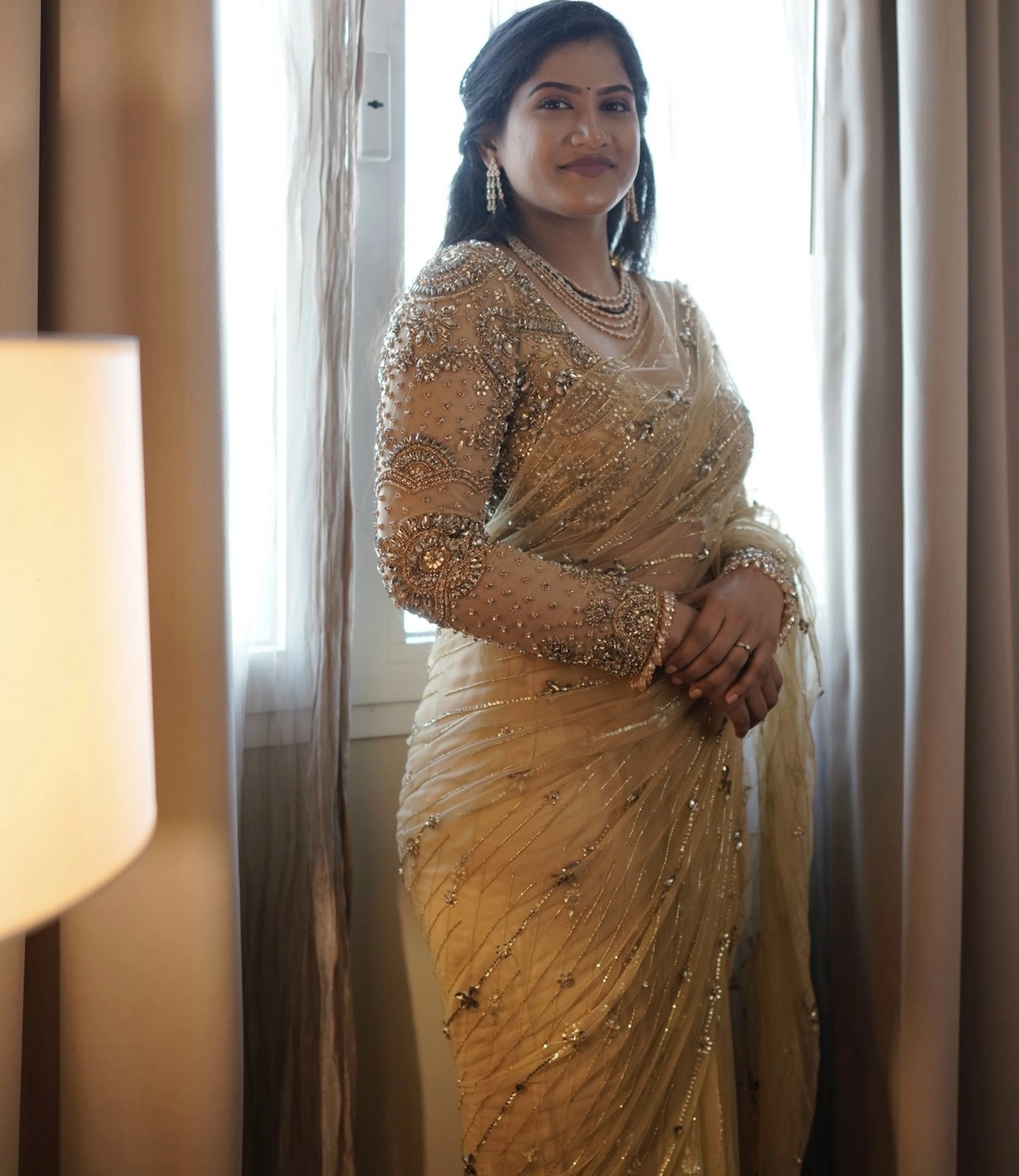 Bride Sree from Dubai in a golden beige tulle saree handcrafted by team Archana Karthick.