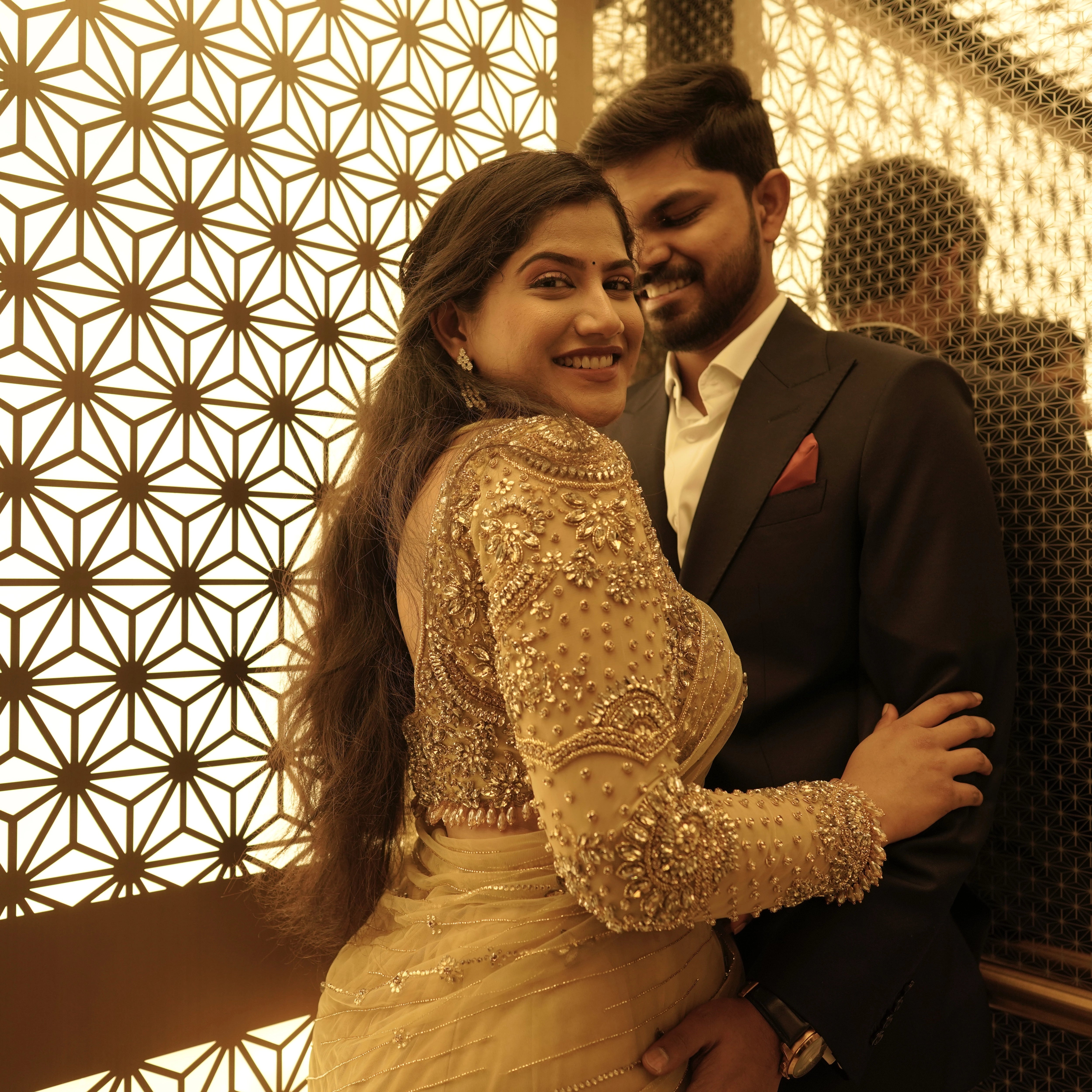 Bride Sree from Dubai, posing with groom in a golden beige tulle saree handcrafted by team Archana Karthick.