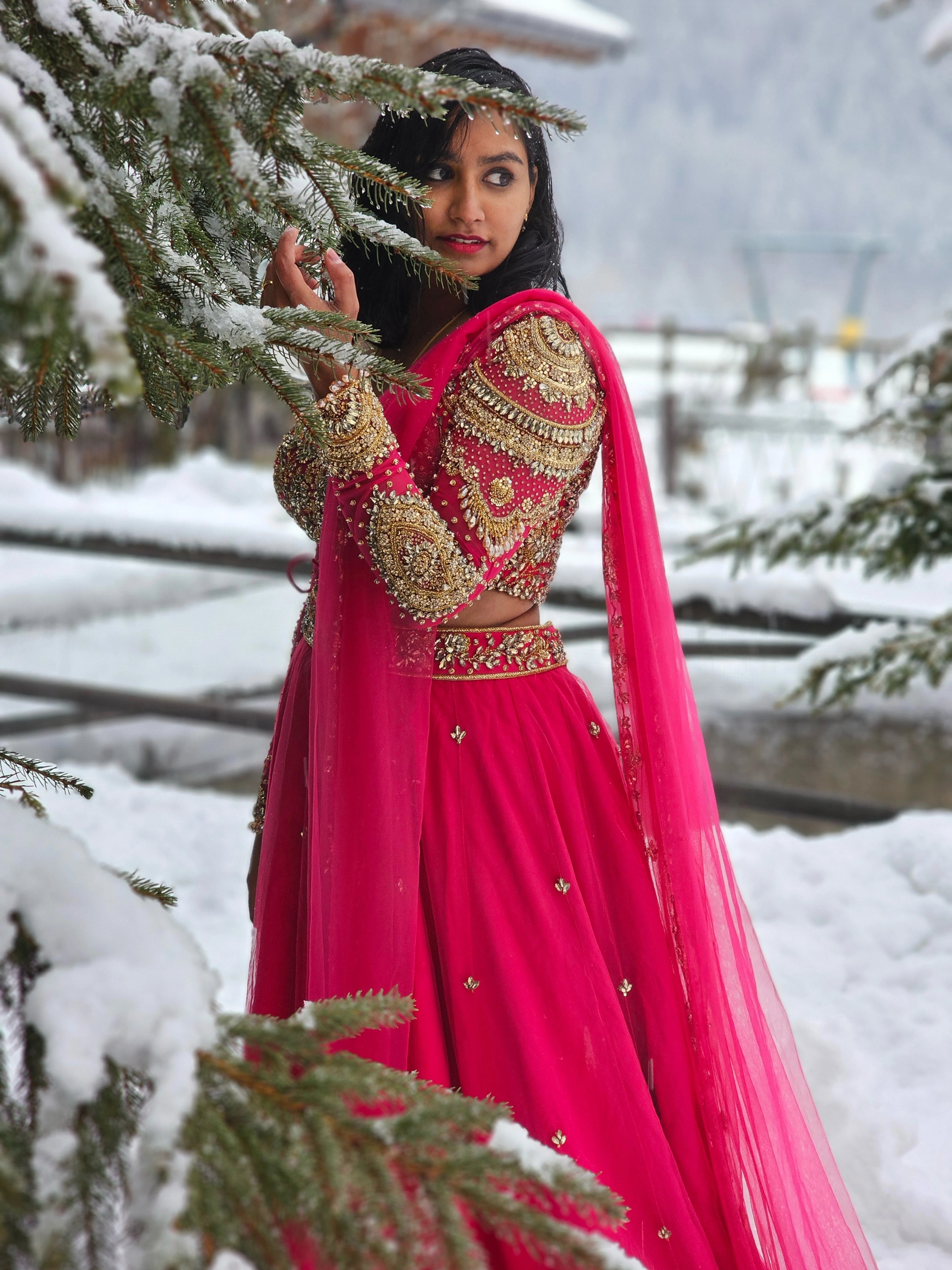 Bride Steffy from Italy, posing for photo in a pink tulle reception lehenga by team Archana Karthick.