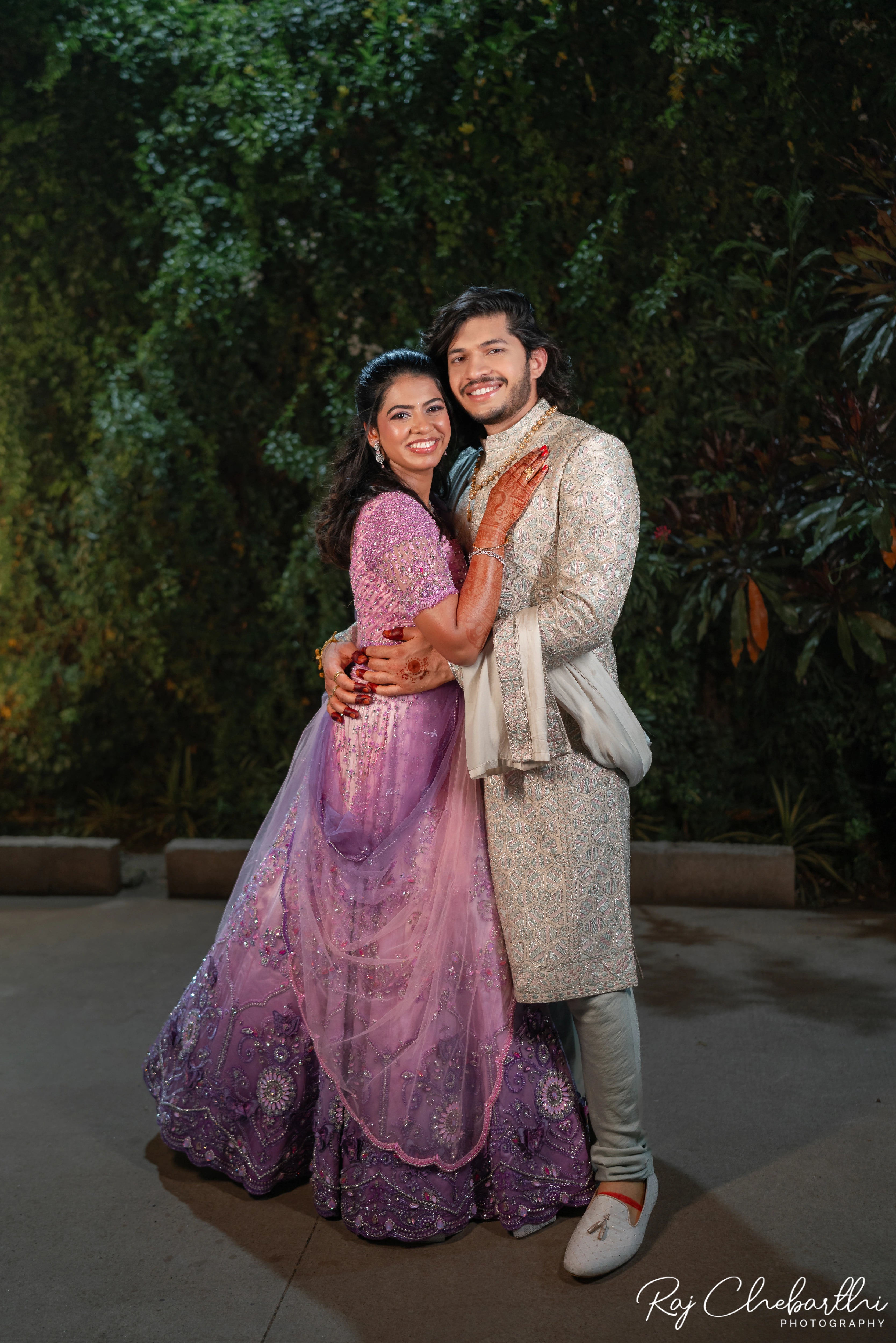 Bride Subhiksha from US posing with groom in a lavender-pink lehenga by Archana Karthick