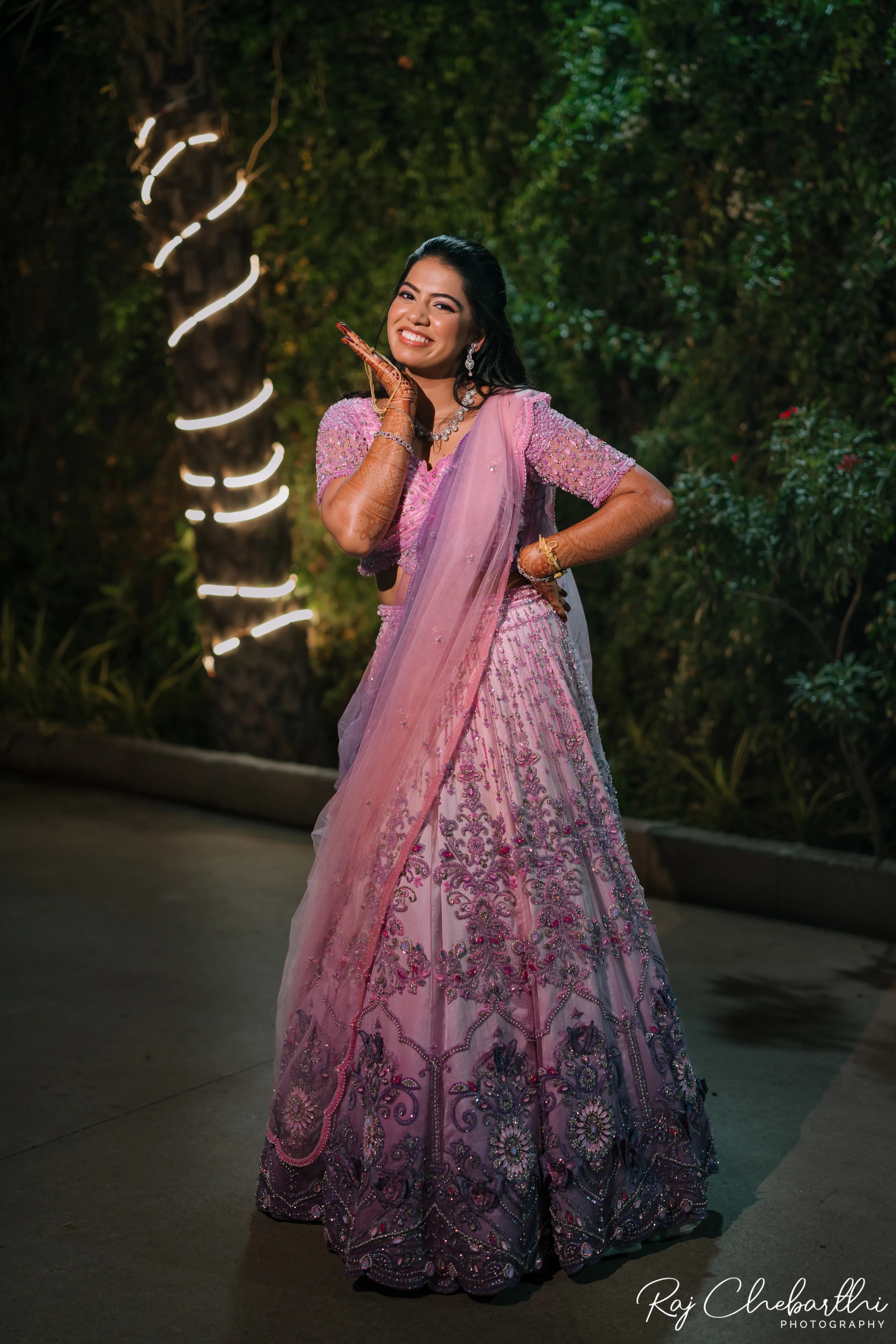 Bride Subhiksha from US smiling in a lavender-pink lehenga by Archana Karthick