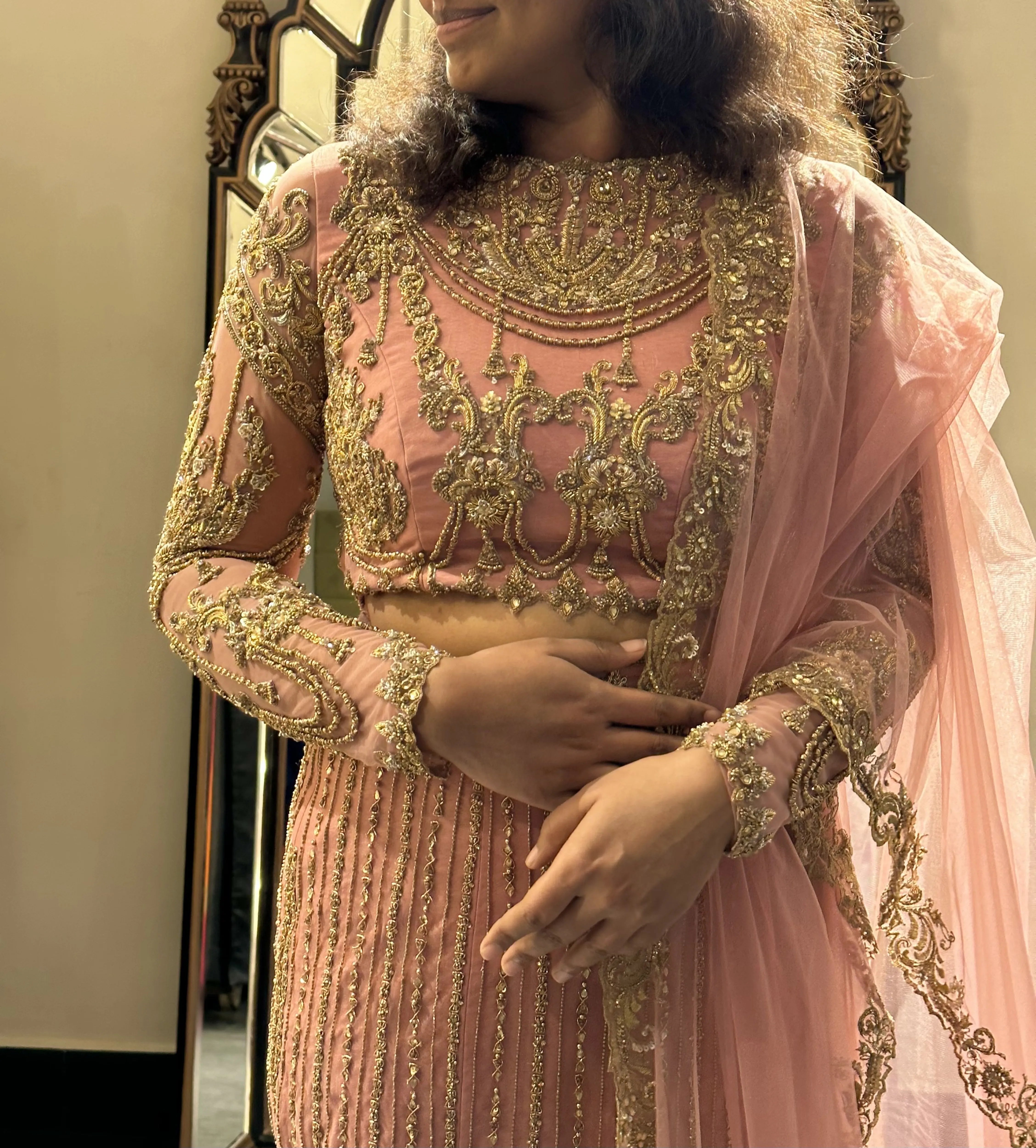 Bride Sushimita from US smiles during her fittings in an onion pink tulle lehenga by team Archana Karthick.