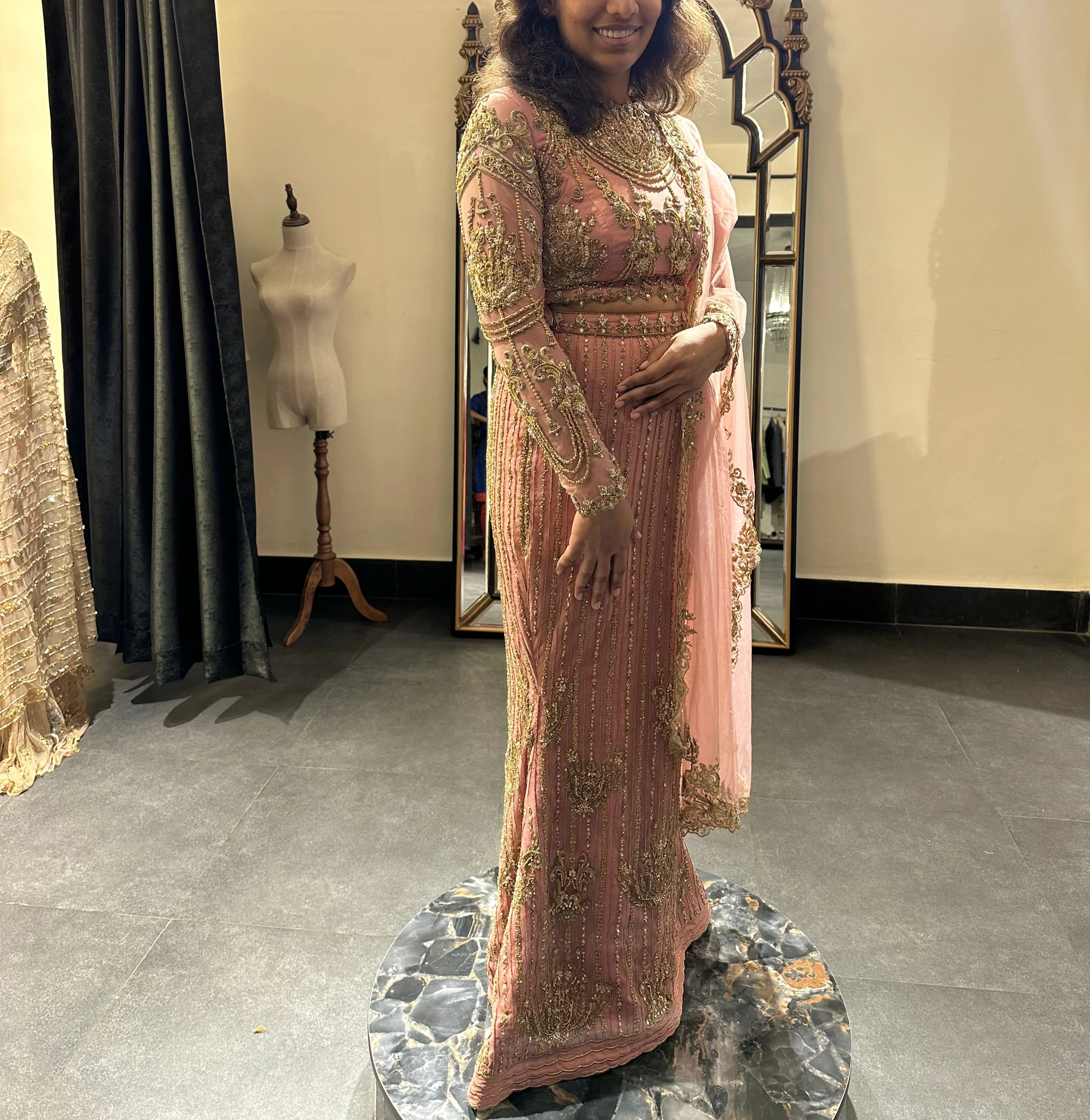 Bride Sushimita from US smiling during her fittings in an onion pink tulle lehenga by team Archana Karthick.