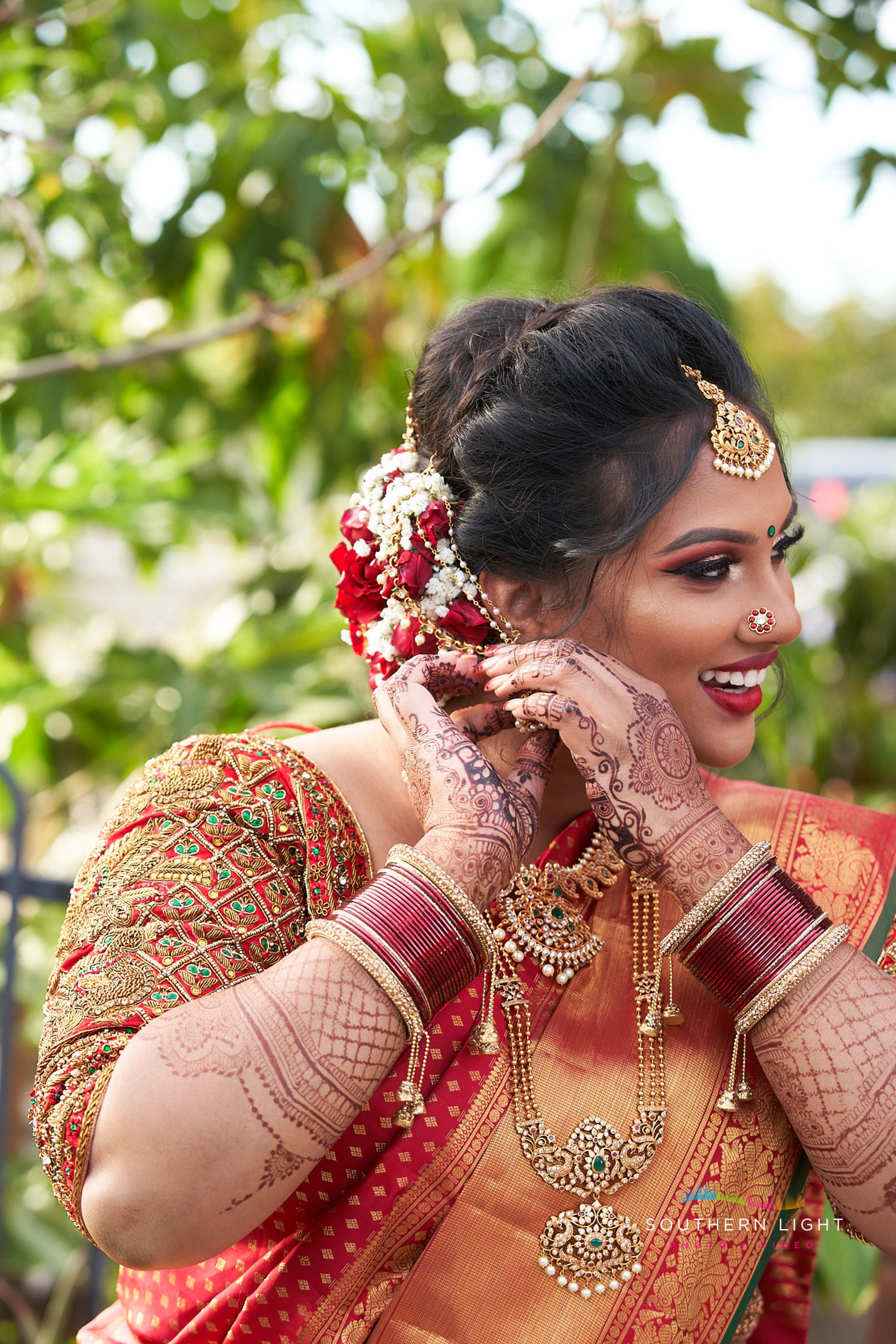 Bride Thena from Australia in a red silk blouse by Archana Karthick