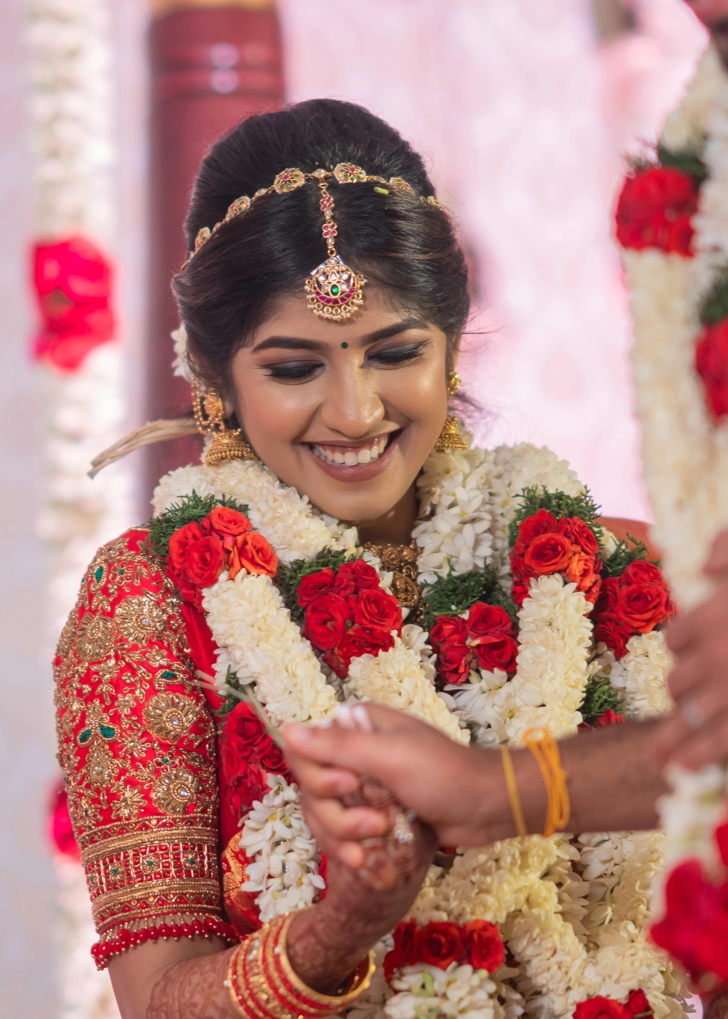 Bride Vaishali Dheenan in a red silk blouse for her muhurtham, handcrafted with zardozi, sequins, kundan, crystals, beads and resham by team Archana Karthick.