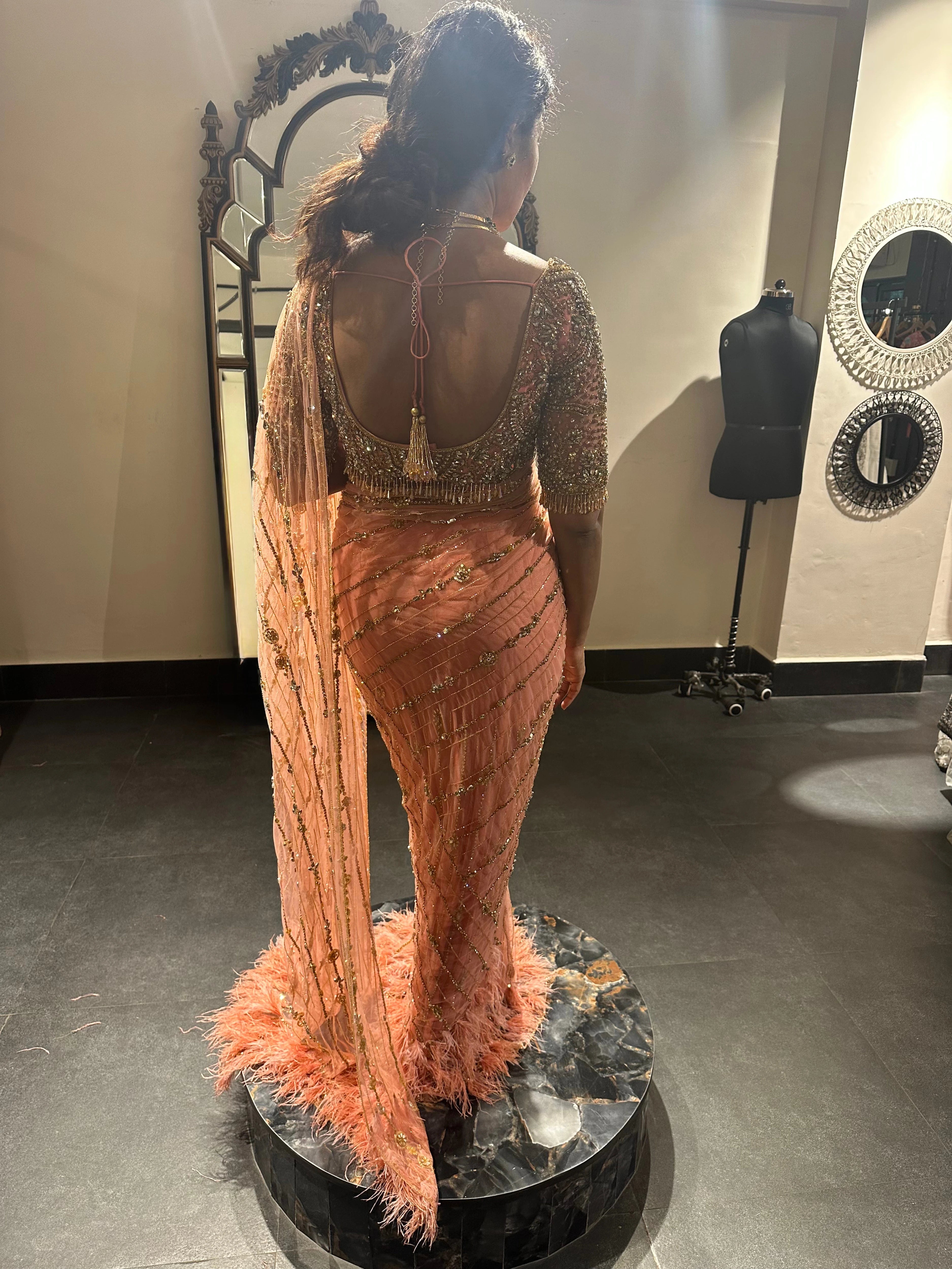 Bride Vaishali from Dubai during her fittings in a peach pink saree handcrafted by team Archana Karthick.