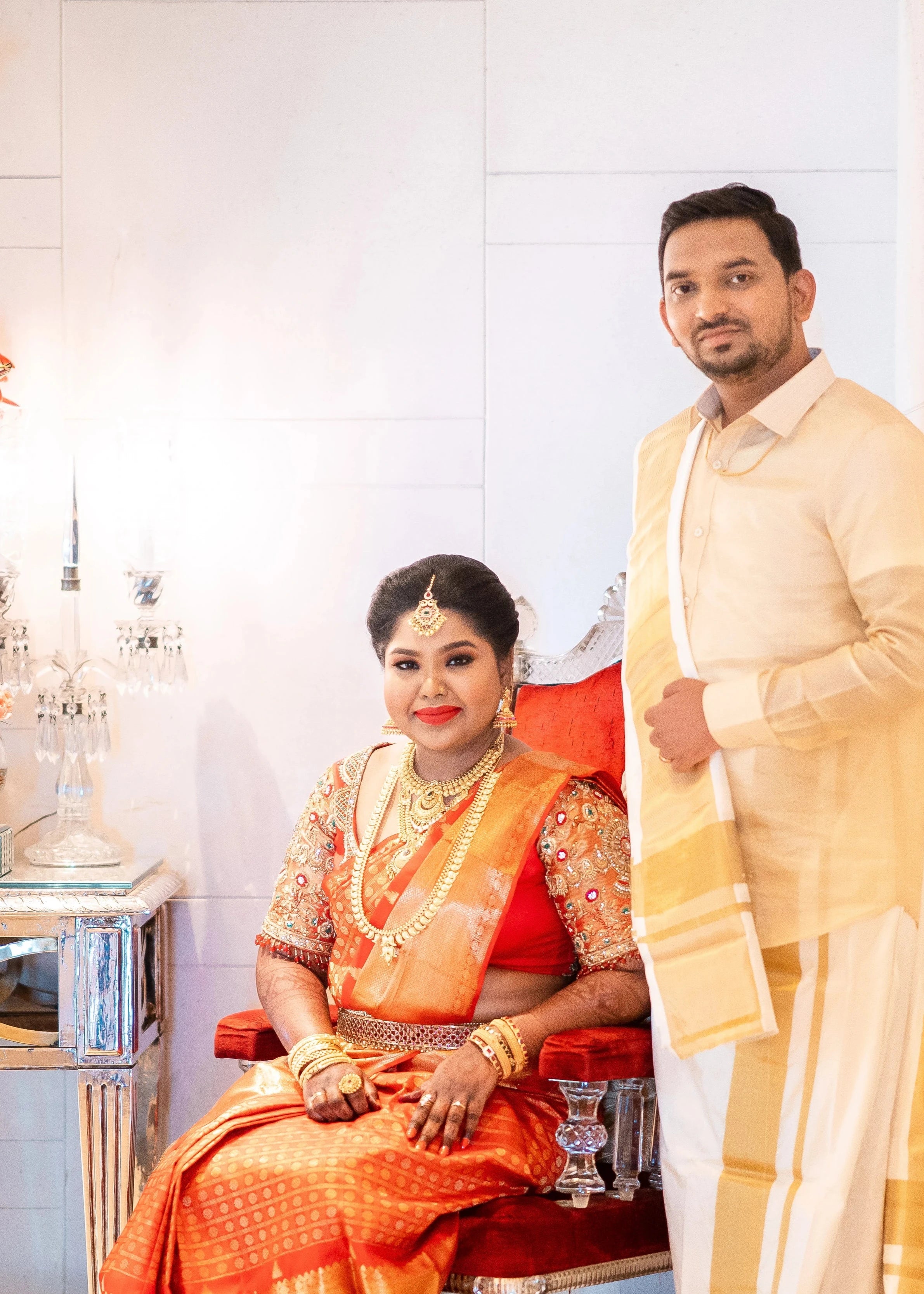Bride Vanmathi from Chennai with groom in a red and gold silk blouse for her wedding, handcrafted with zardozi, stones, kundan, beads and resham by team Archana Karthick.
