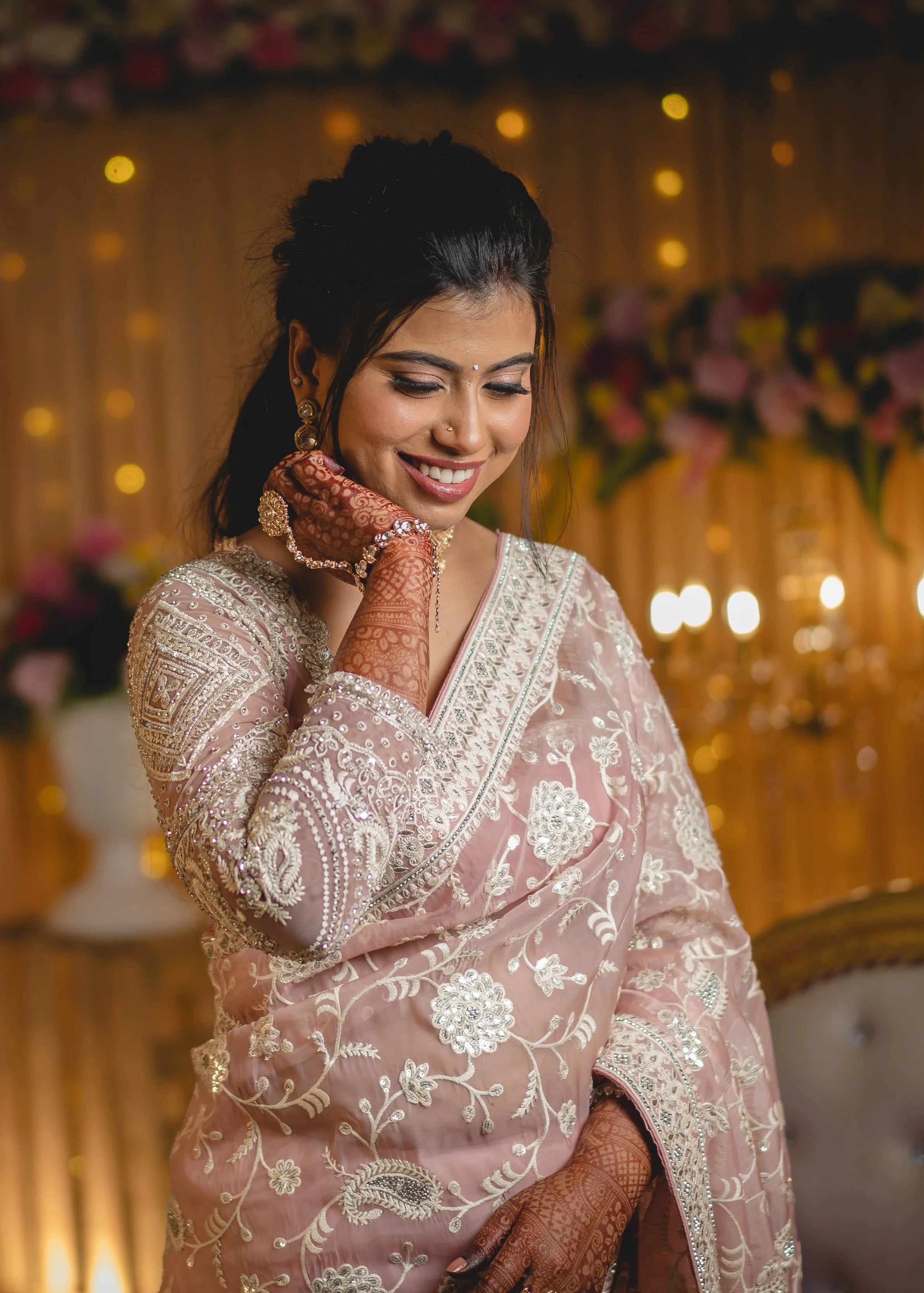 Bride Vidhira in a soft blush tulle blouse for her reception, handcrafted with rhinestones, resham and crystals by team Archana Karthick.