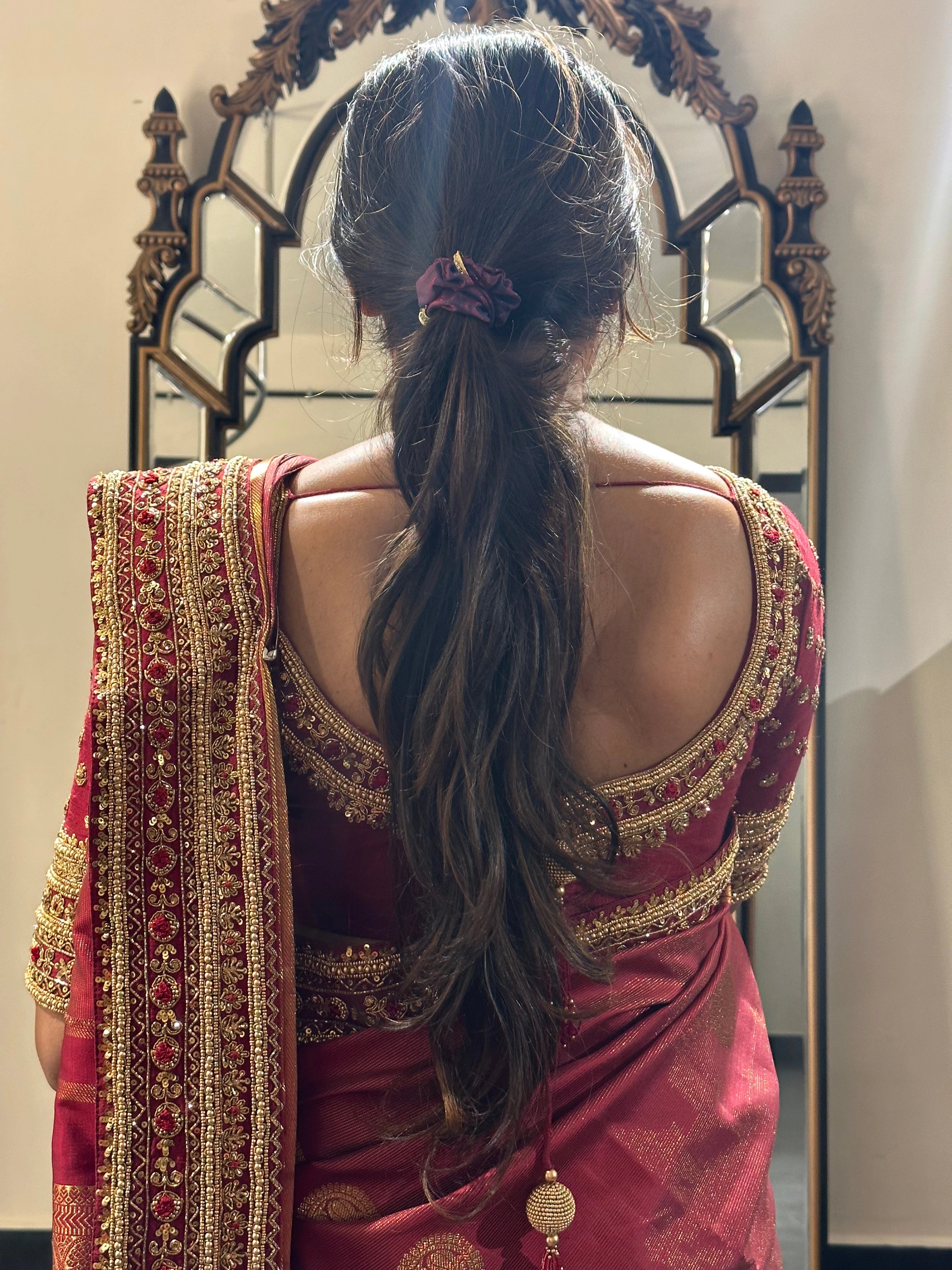 Bride Vidhyashree Ravi during fittings in a maroon silk blouse and saree border handcrafted by team Archana Karthick.