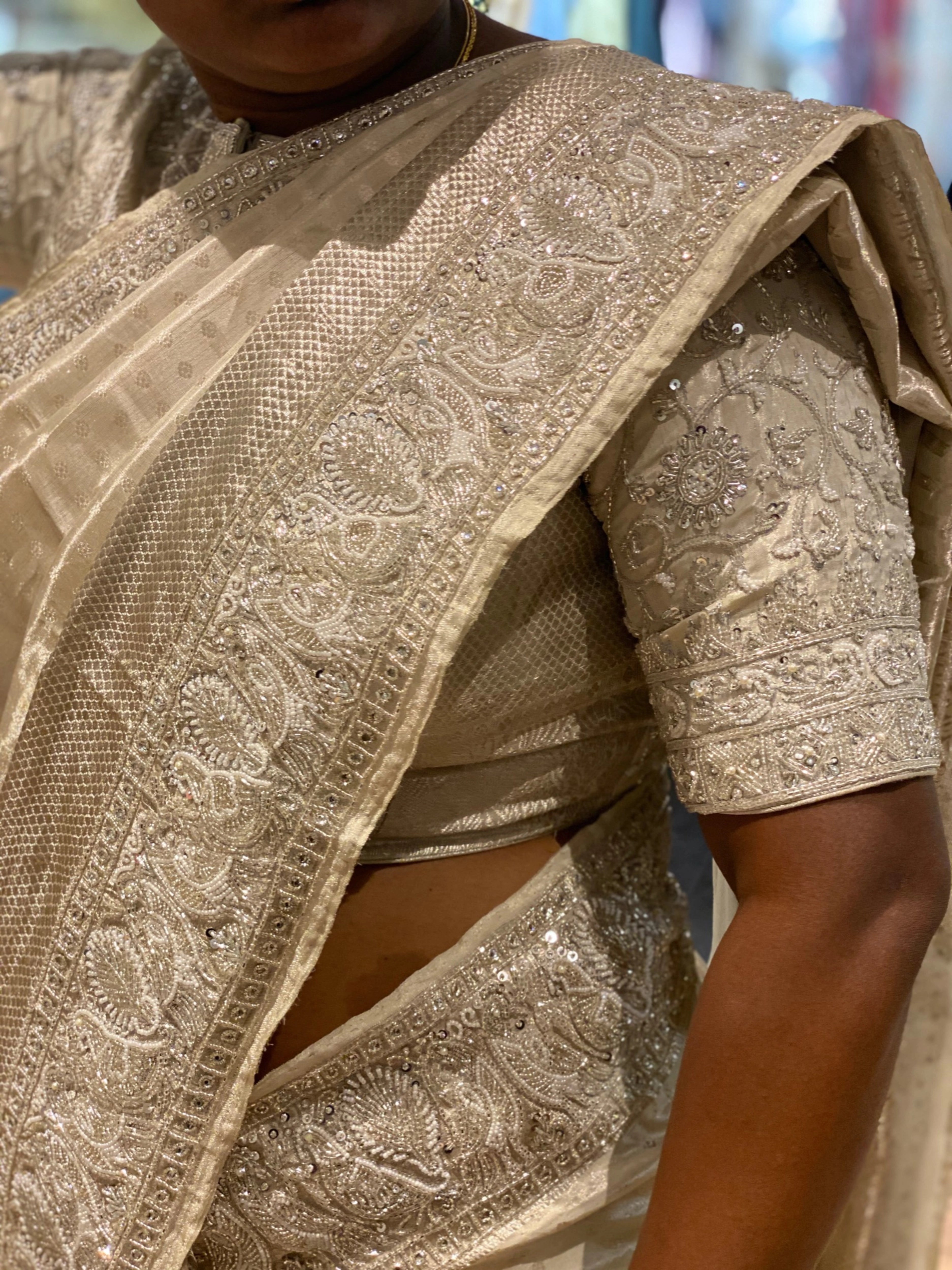 Bride Viniba from Chennai showcasing in an ivory and silver silk blouse and saree border handcrafted intricately with beads, stones, sequins, cutdana and zardozi.