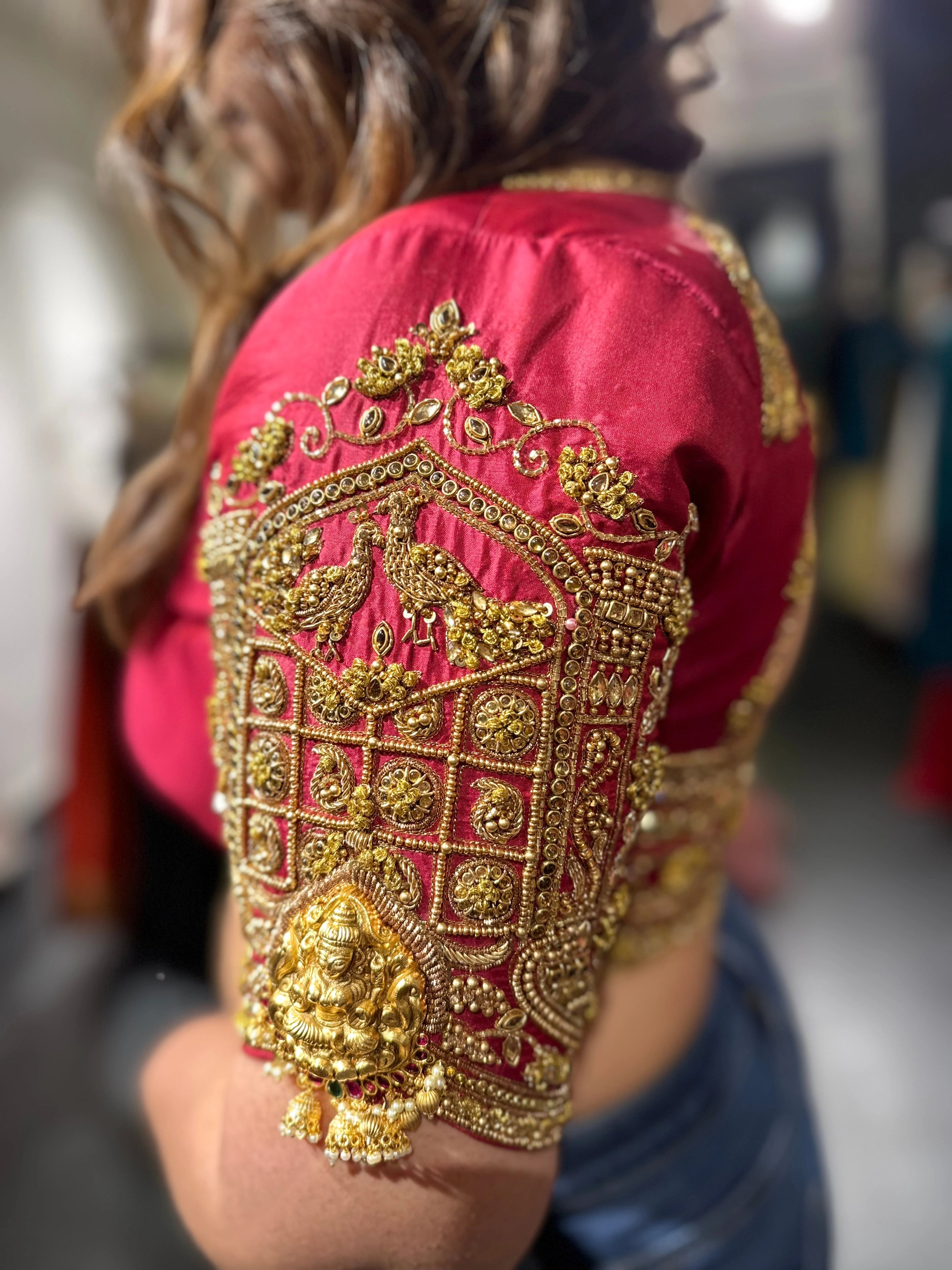 Bride Visali from USA during the fittings in a red raw silk blouse handcrafted by team Archana Karthick.