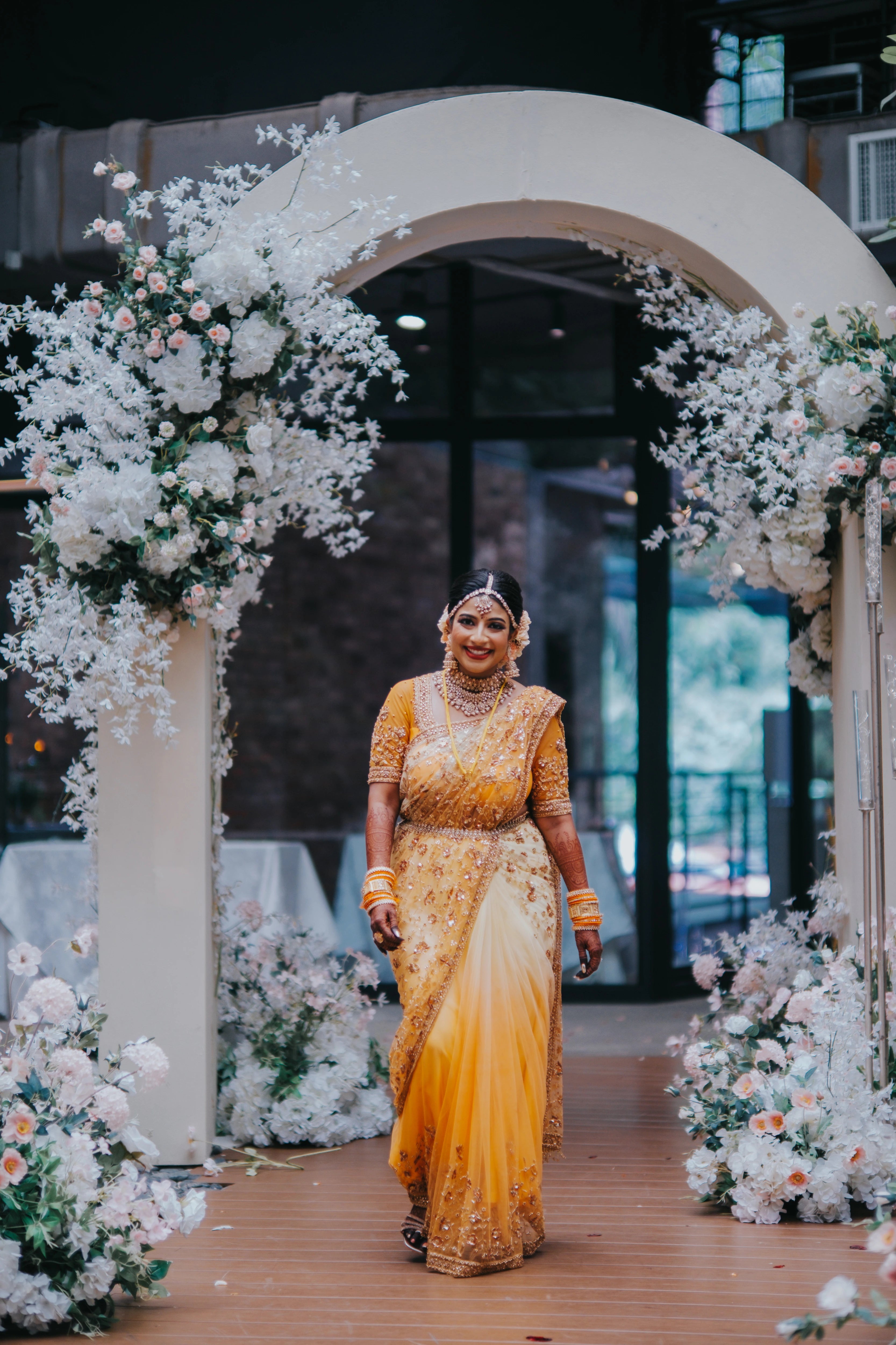 Bride Vishalini from Malaysia in a mustard and ivory tulle saree, handcrafted by team Archana Karthick.