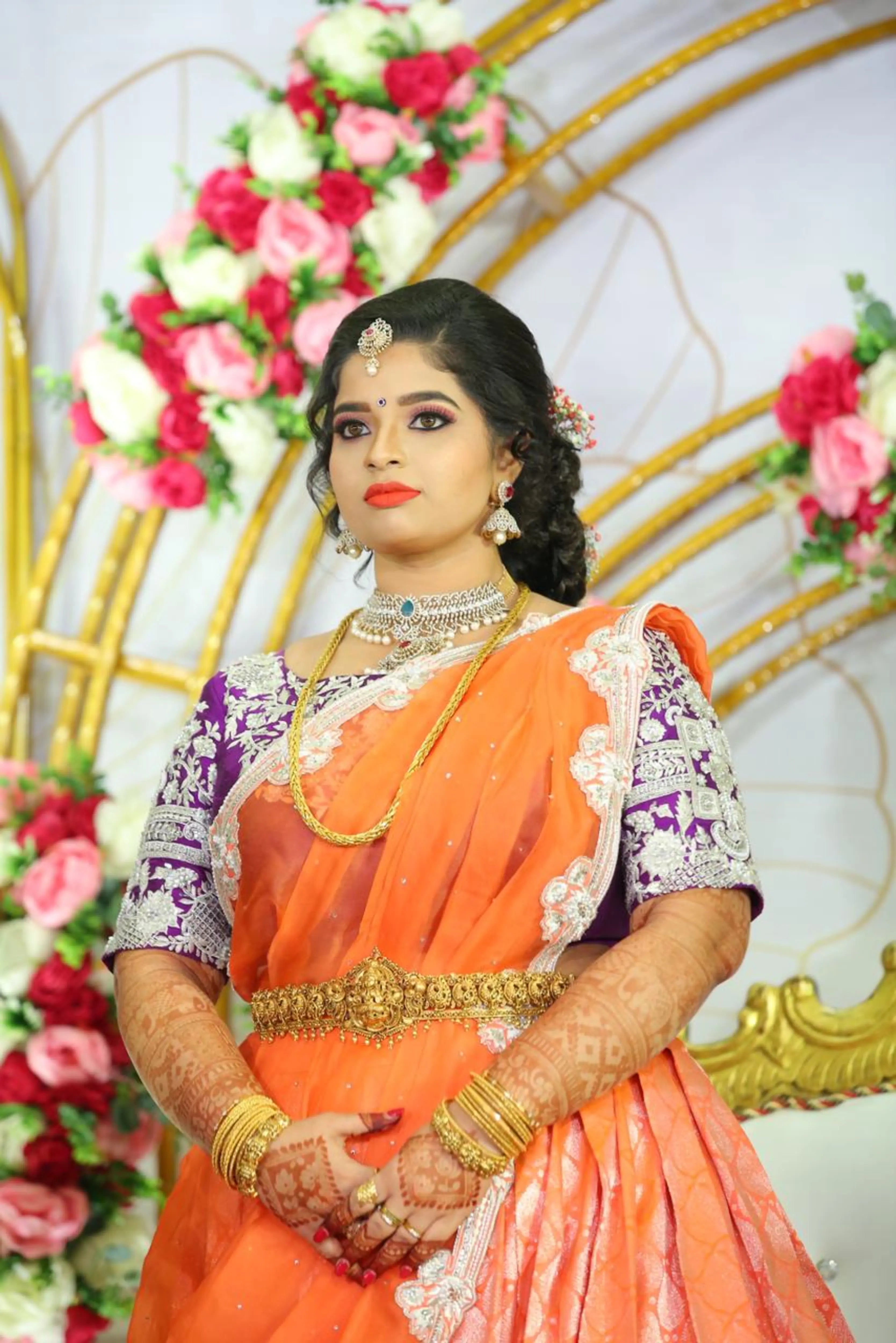 Bride Vishnulakshmi posing in a purple raw silk blouse and saree border, handcrafted with beads, zari, stones, pearls and sequins by team Archana Karthick.