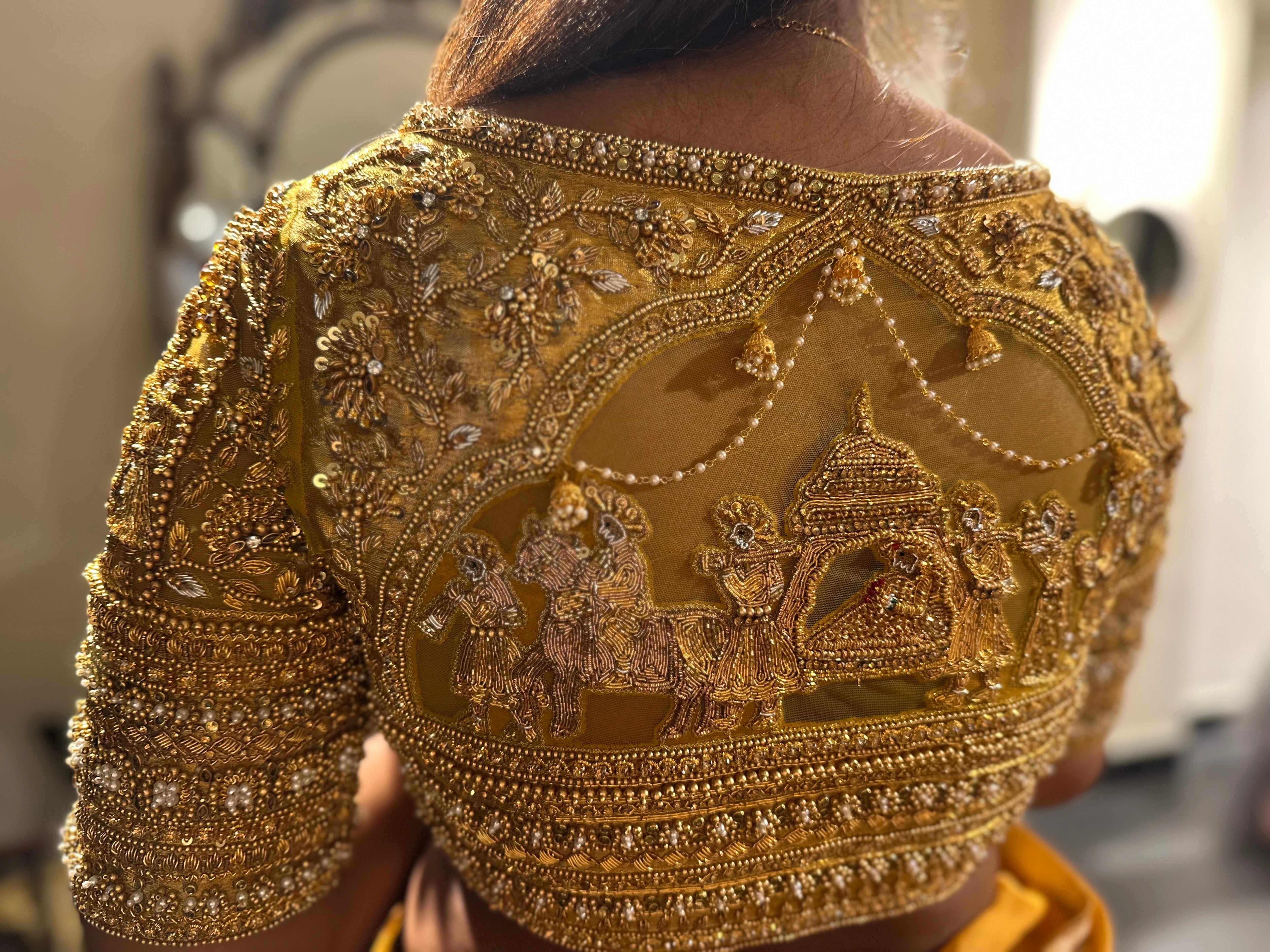 Bride Vishu Priya during fittings in a gold silk blouse, handcrafted by team Archana Karthick.