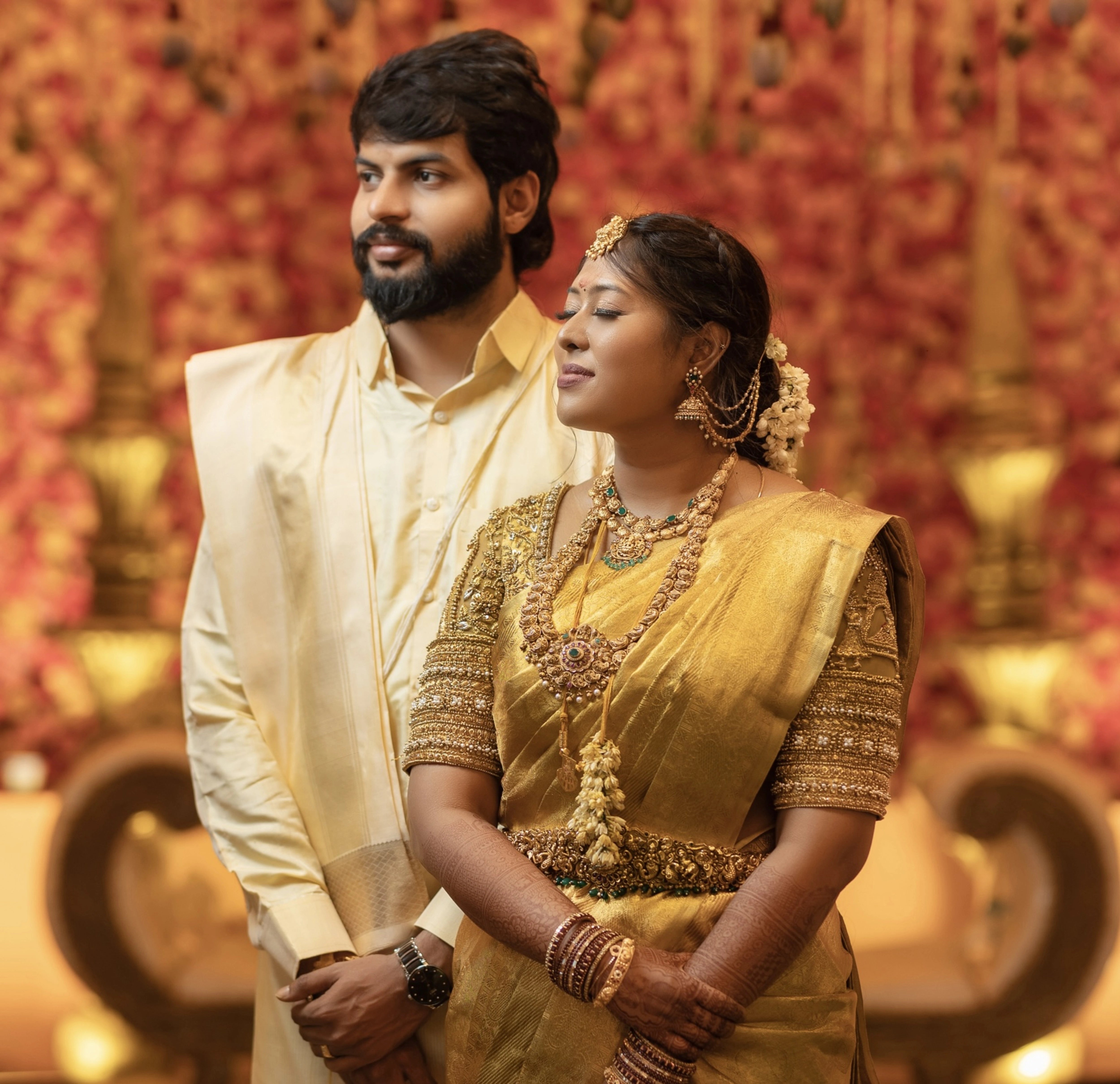 Bride Vishu Priya with groom in a gold silk blouse, handcrafted by team Archana Karthick.