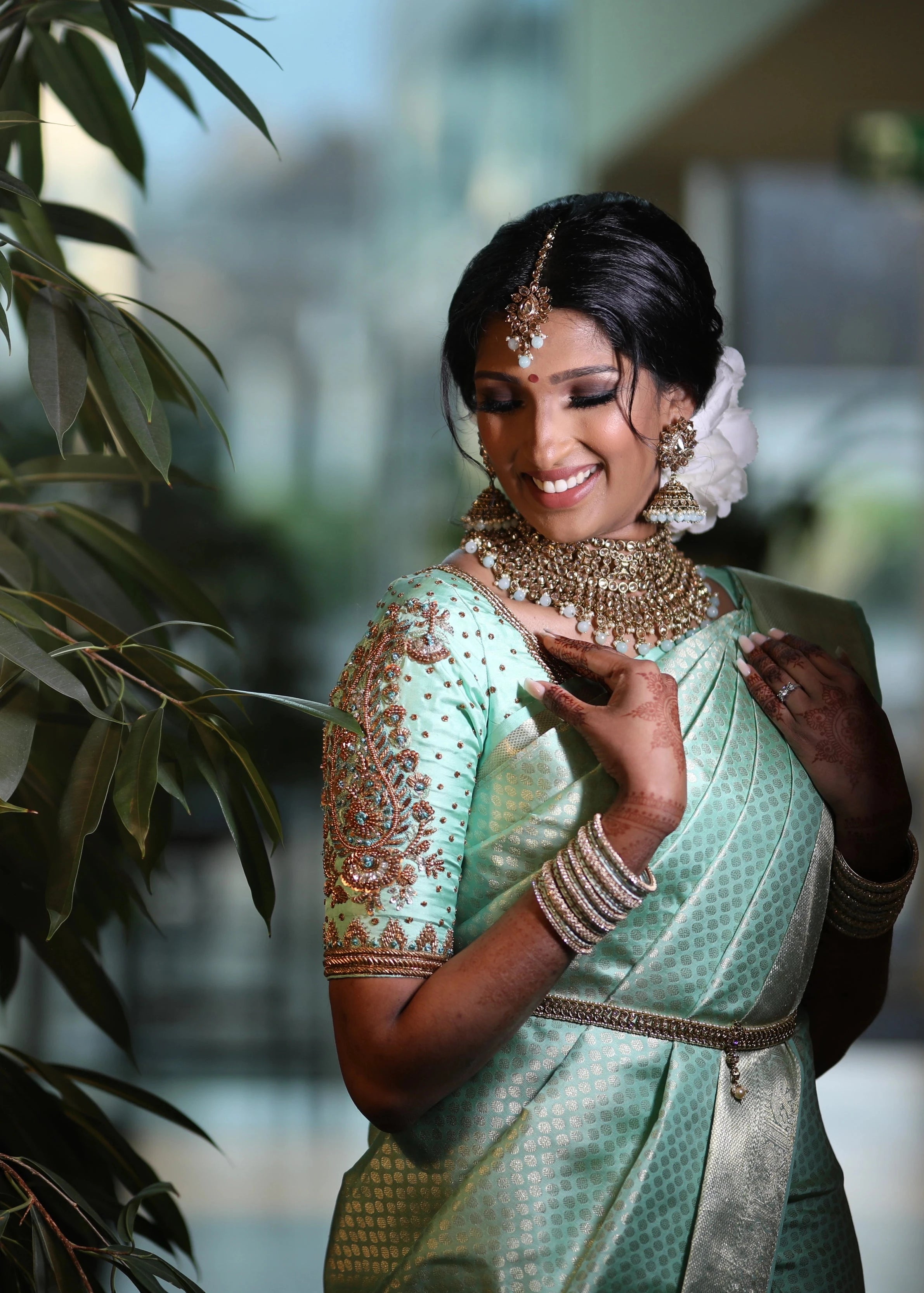 Bride Vithusika from Switzerland in an aquamarine silk concept blouse for her engagement, handcrafted by team Archana Karthick.