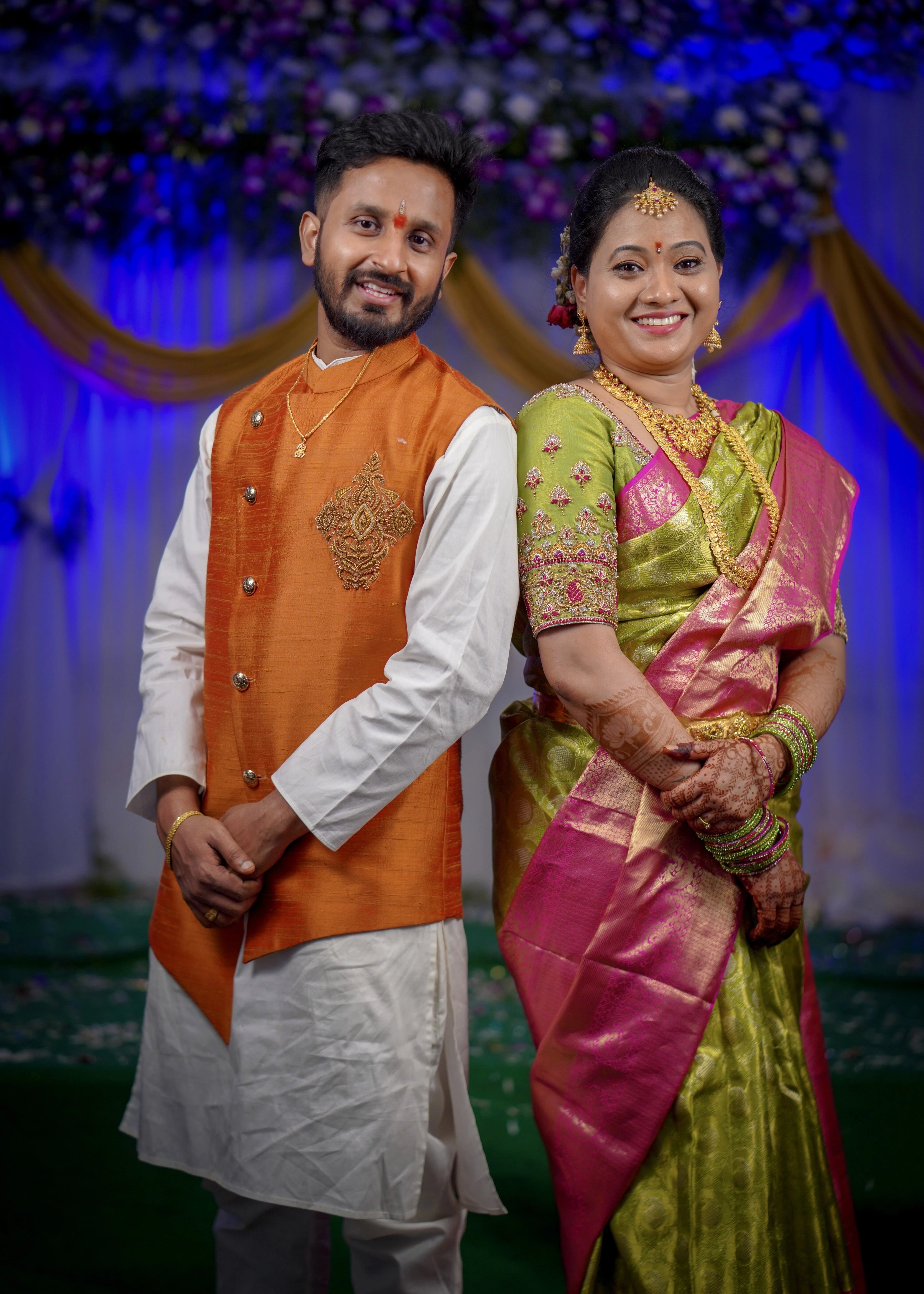Bride and groom from Seattle, USA smiling in a handcrafted blouse and bandhgala set designed by Archana Karthick.