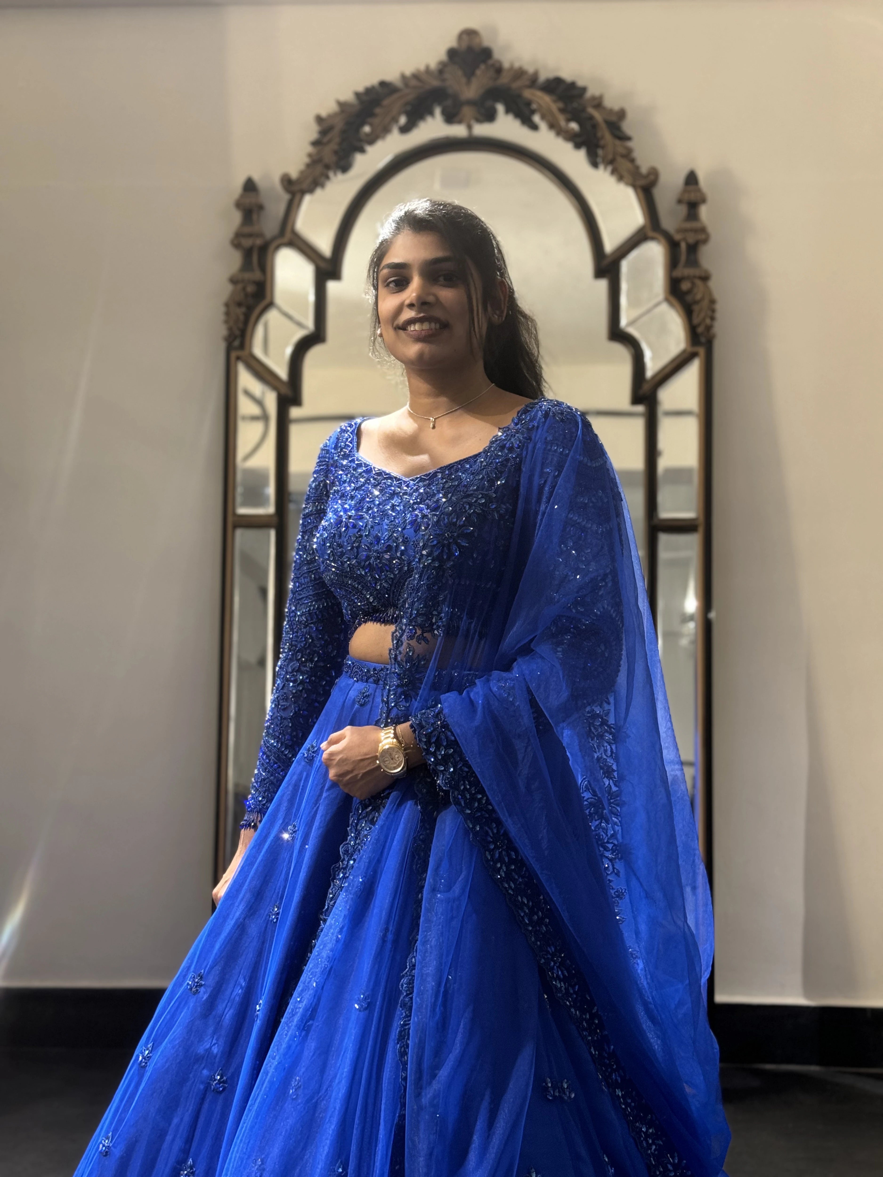 Bride Snegha from Australia during her fittings in a blue tulle lehenga, handcrafted with sequins, cutdana, rhinestones and crystals by team Archana Karthick.