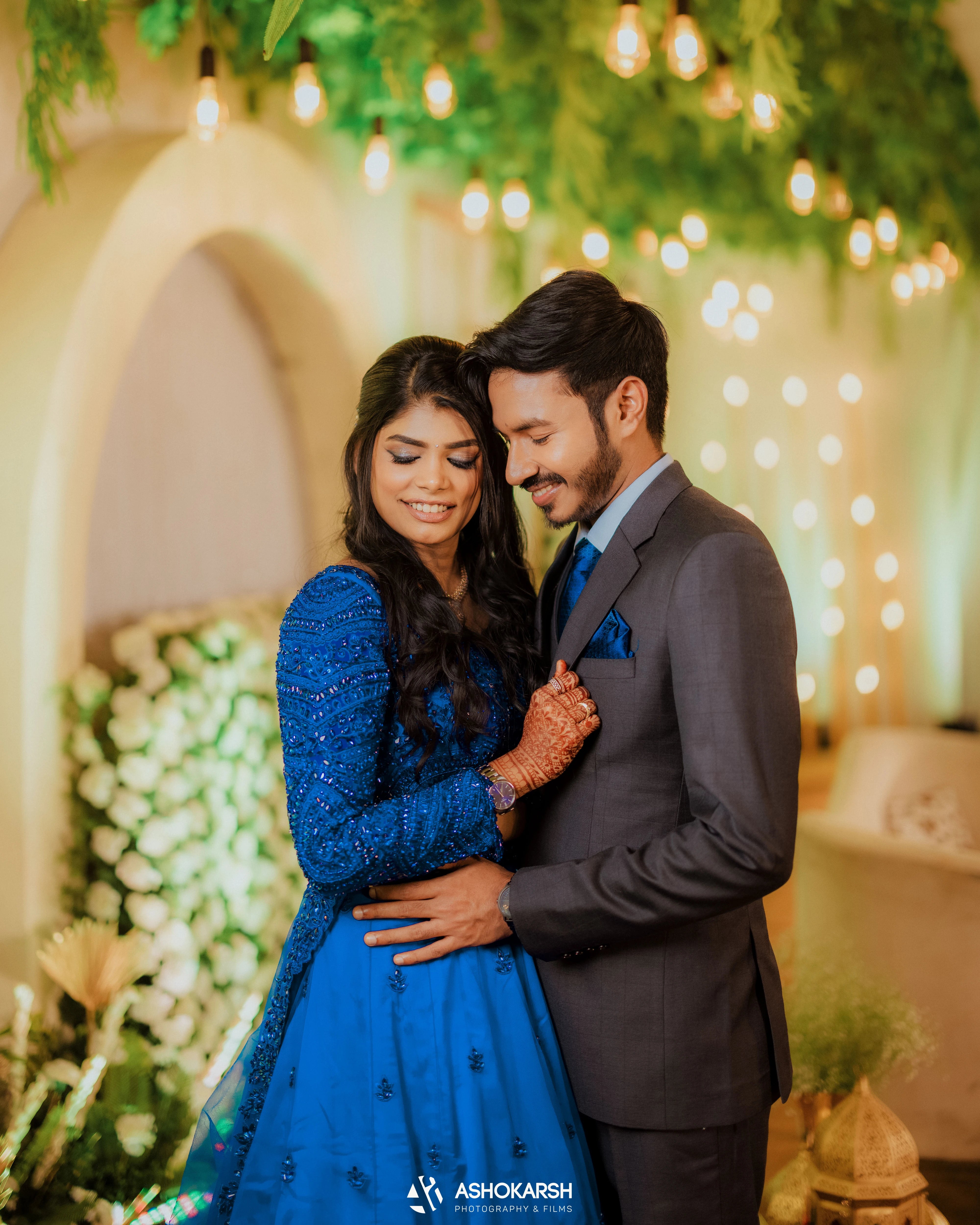 Bride Snegha from Australia posing in a blue tulle lehenga, handcrafted with sequins, cutdana, rhinestones and crystals by team Archana Karthick.