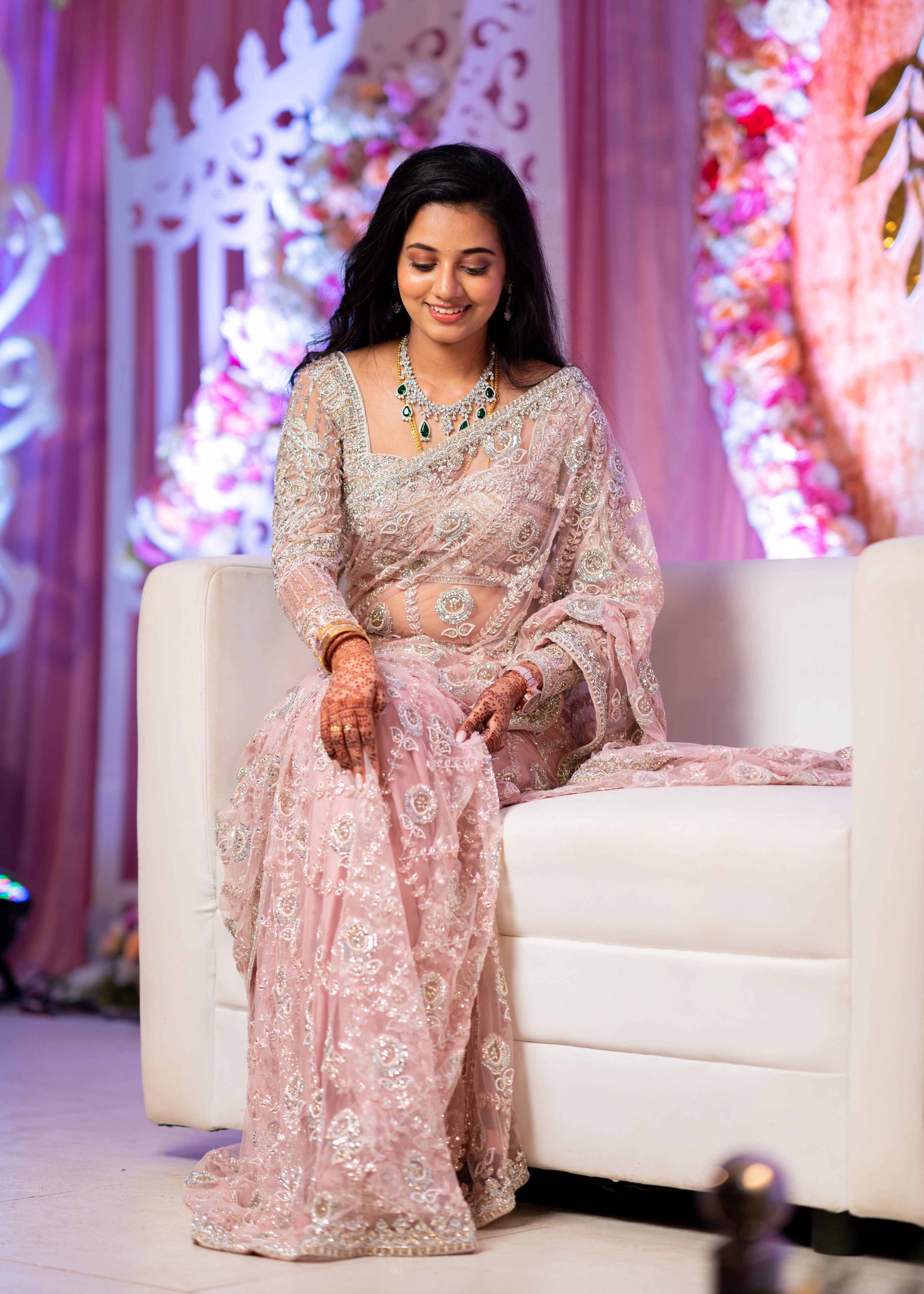Bride from Berlin looking down in a concept pink tulle saree designed by Archana Karthick handcrafted with stones, crystal beads, cutdanas, resham work and sequins.