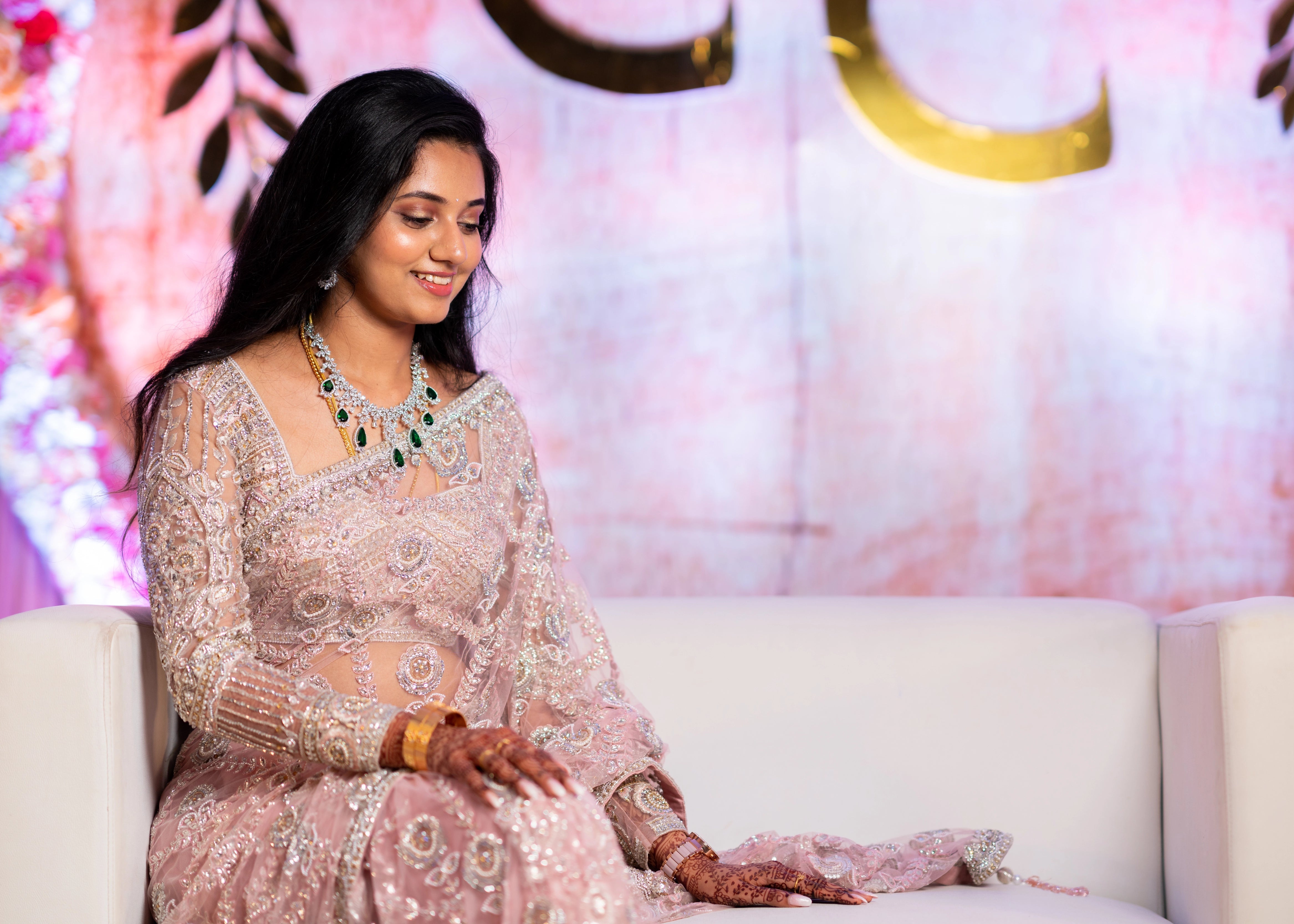 Bride from Berlin on the couch in a concept pink tulle saree designed by Archana Karthick handcrafted with stones, crystal beads, cutdanas, resham work and sequins.