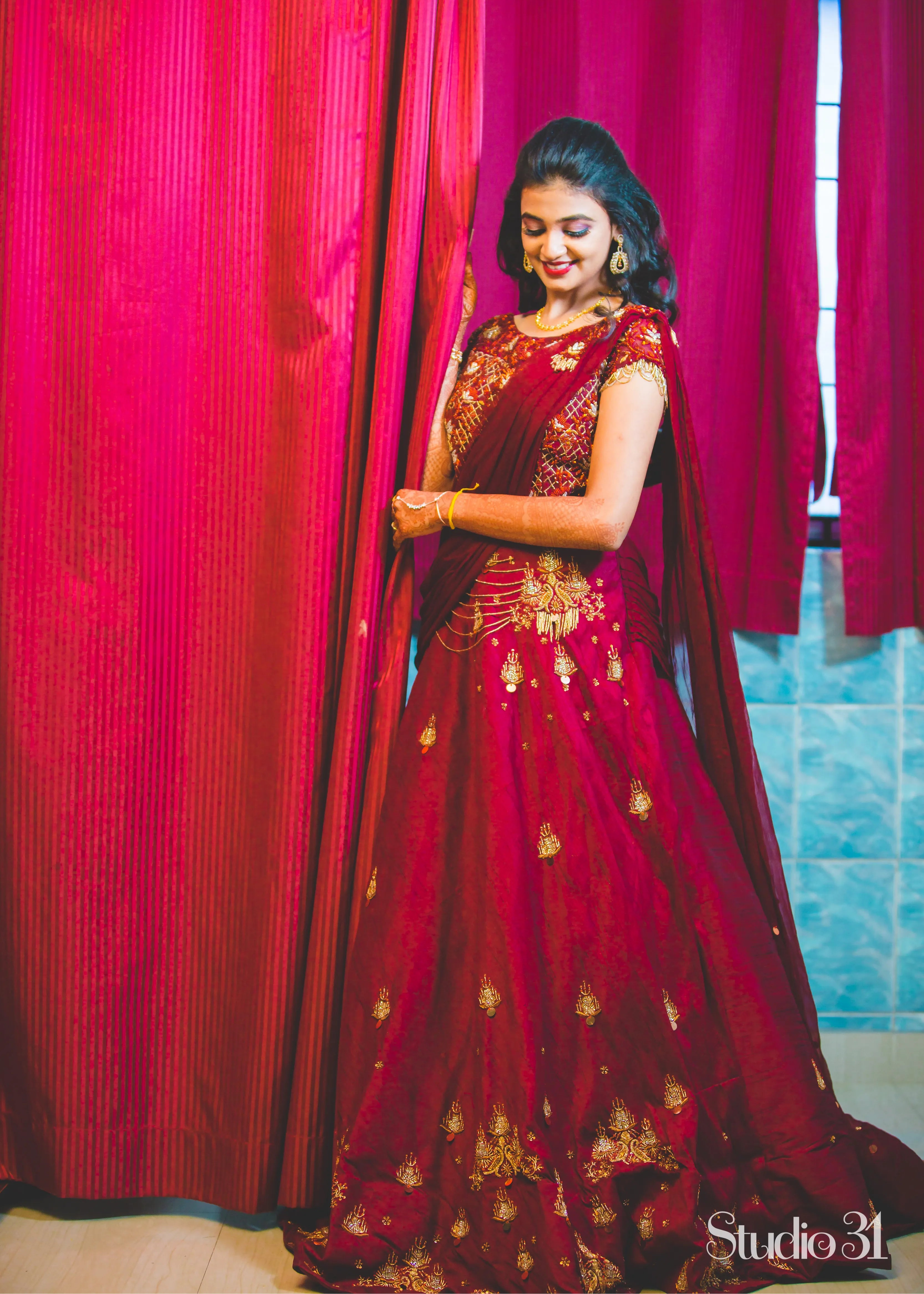 Bride from Chennai in a handcrafted maroon raw silk gown with draped dupatta.