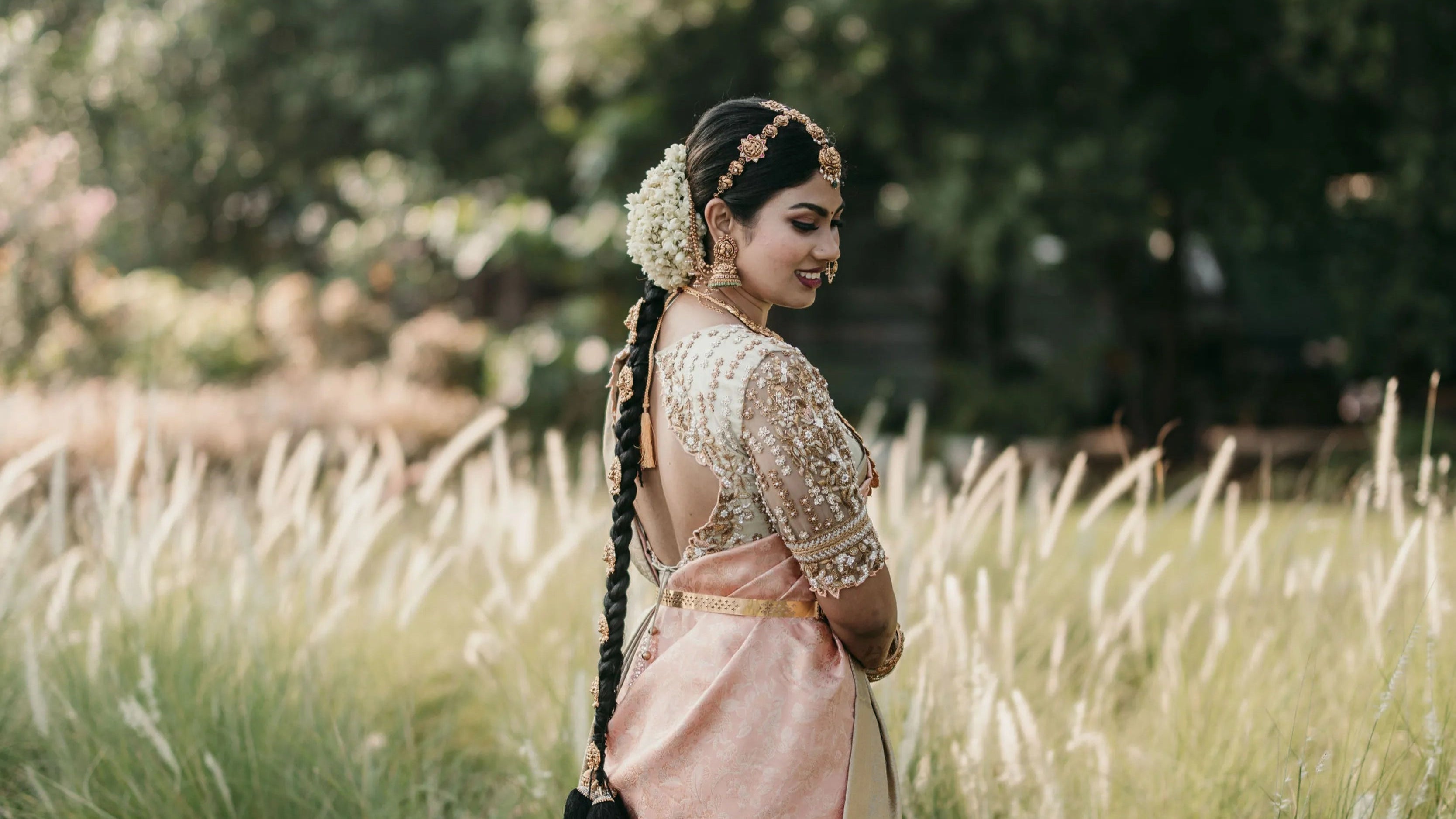 Bride from Chennai posing in a concept blouse in grey tulle and silk, handcrafted intricately with zardozi, crystal beads, stones, pearls and beads. Designed by Archana Karthick.