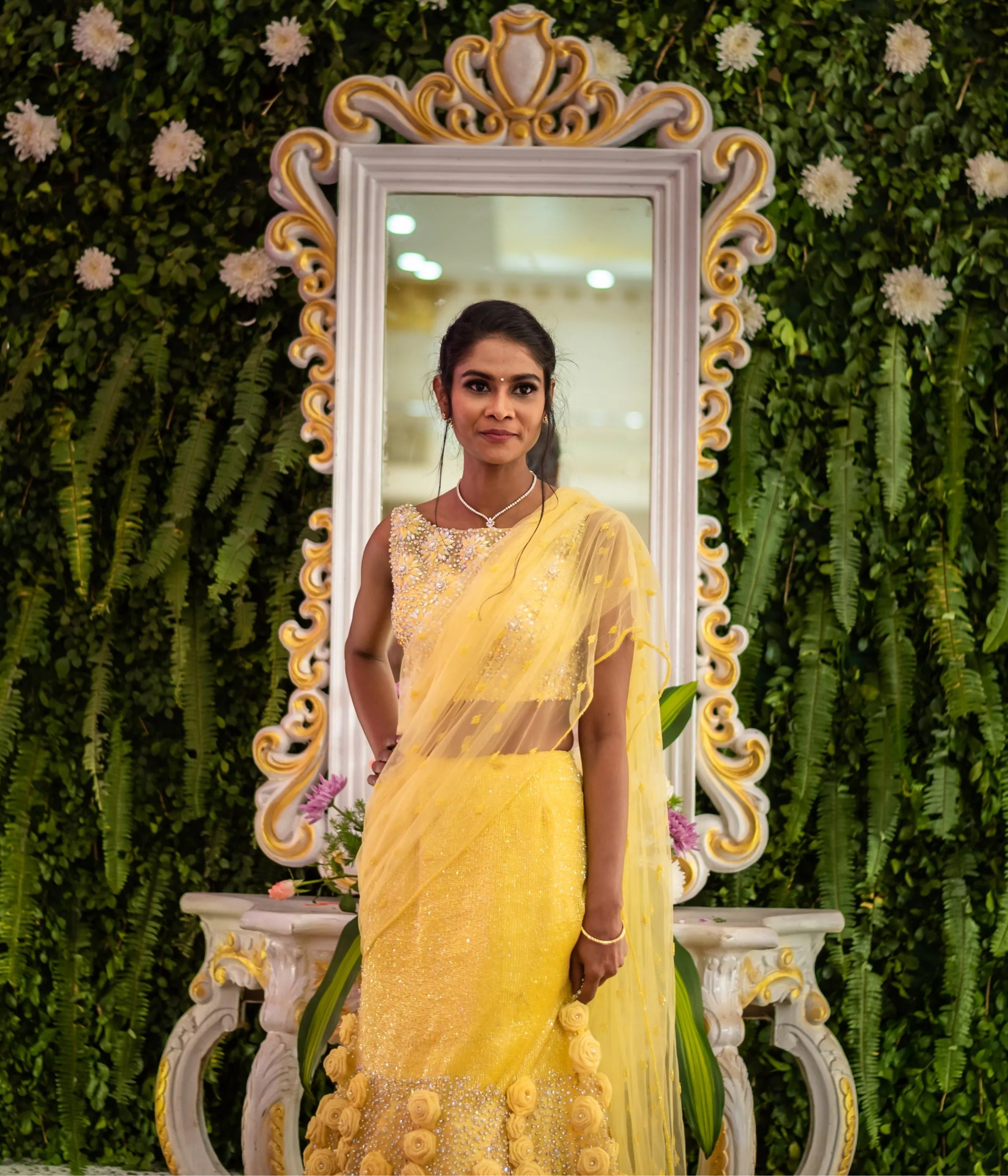 Bride from Chennai posing in handcrafted yellow mermaid lehenga embellished with cut dana, pearls, rhinestones and handmade 3D flowers.