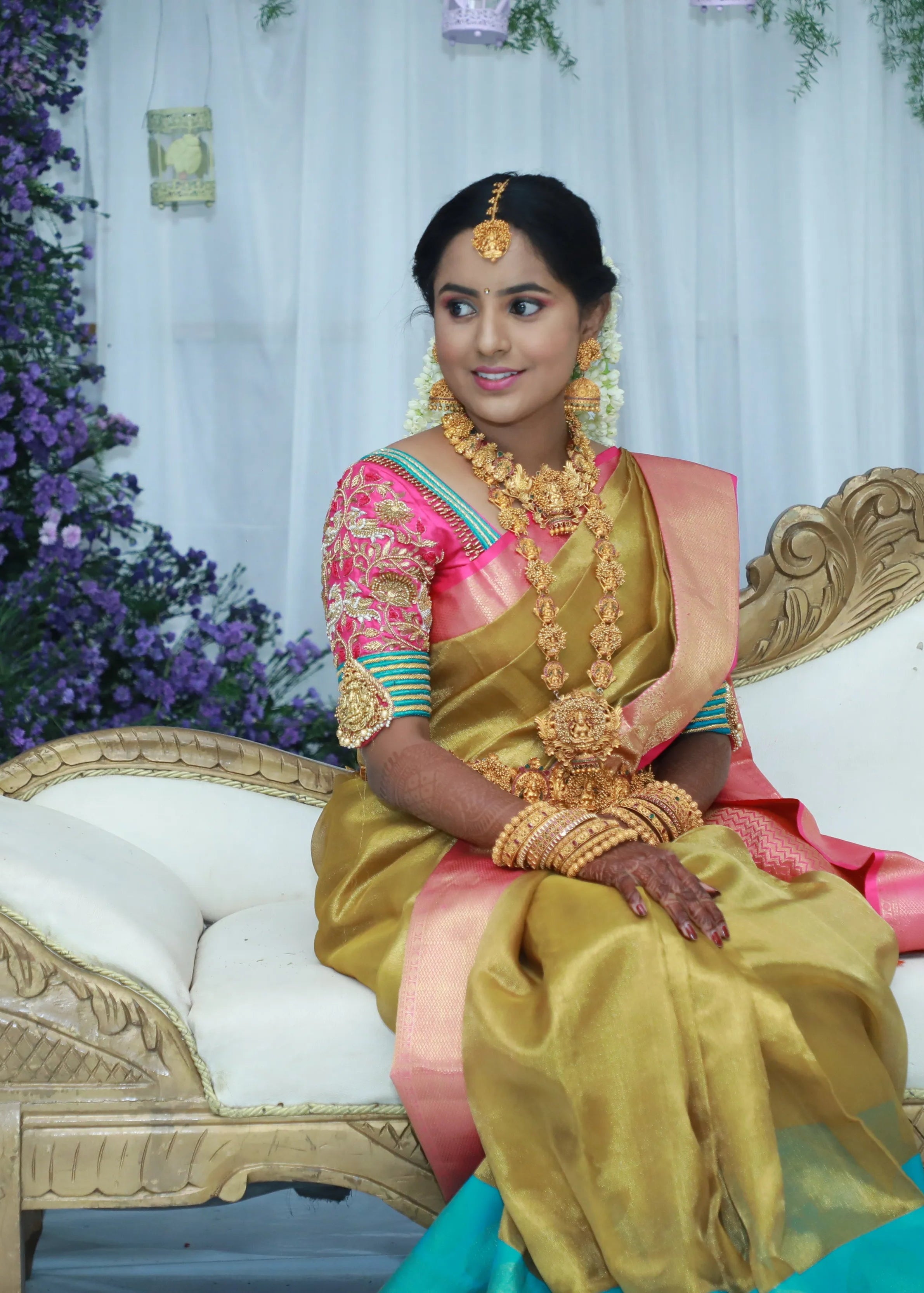 Bride from Chennai seated in pink silk blouse with zardozi, kundan, resham knot work and kundan embellishments. Designed by Archana Karthick