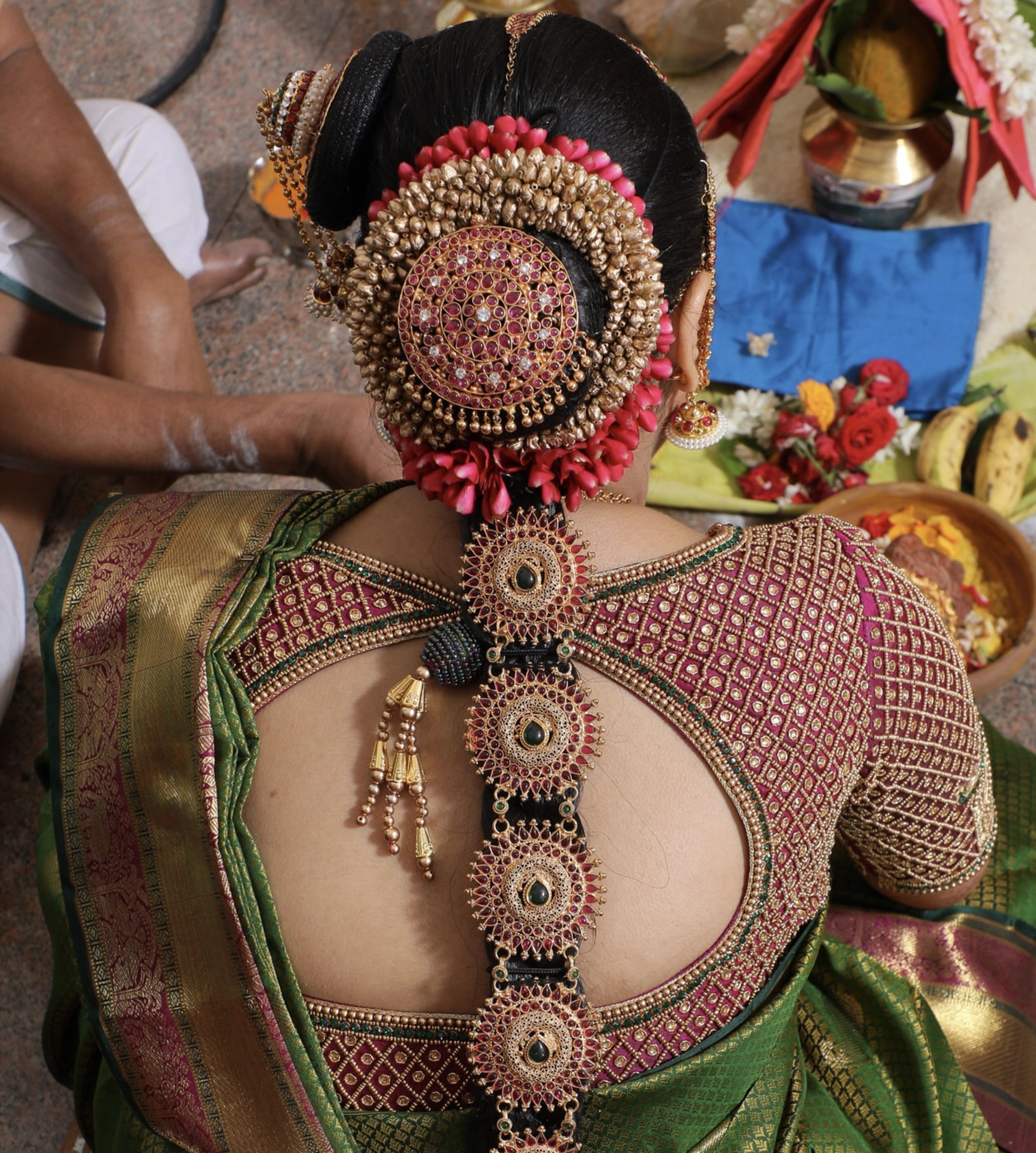 Bride from Chennai showcasing back blouse back design in a silk blouse designed by Archana Karthick handcrafted intricately with zardozi, beads, resham and kundan.