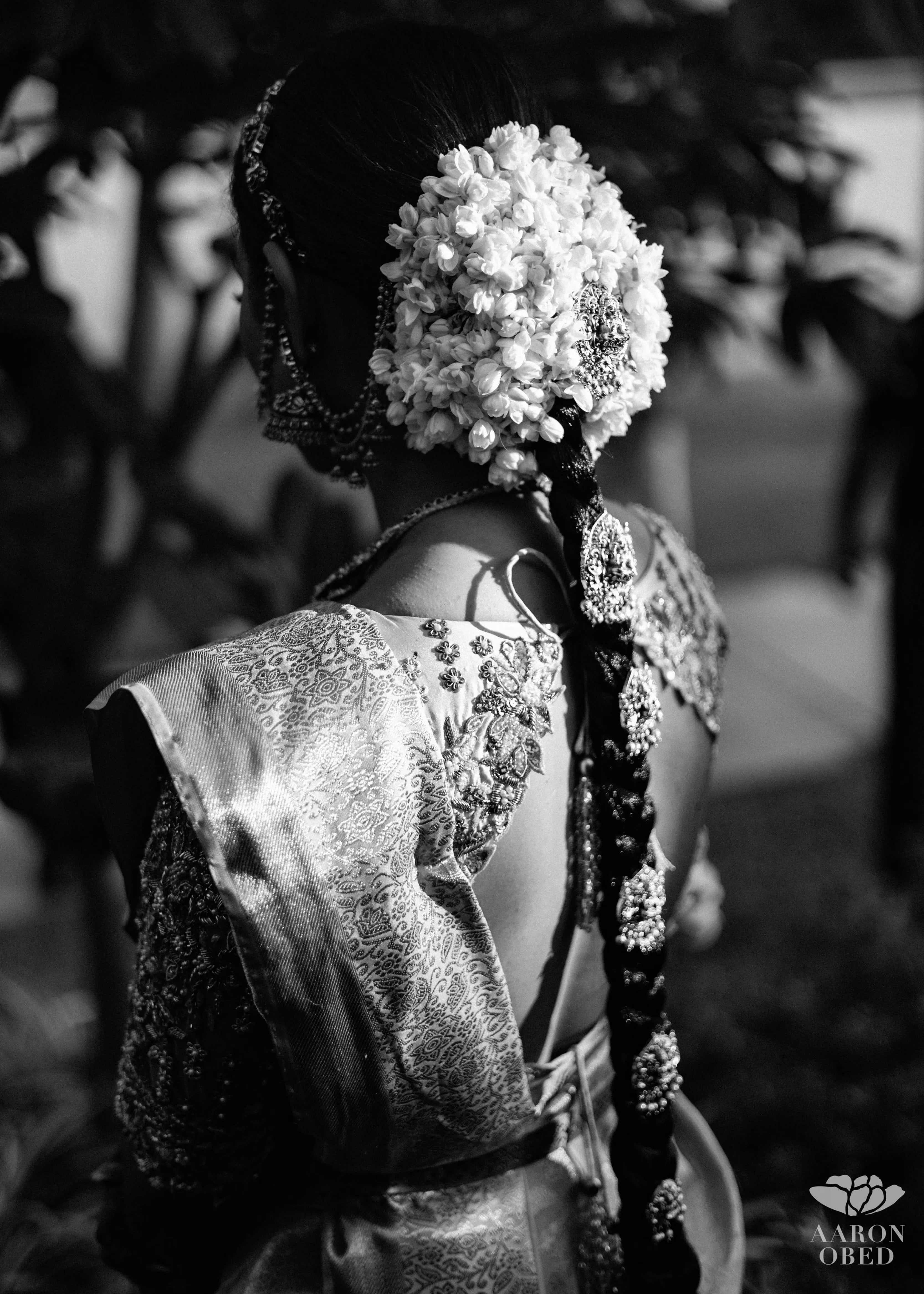 Bride from Chennai showcasing blouse back design in a concept blouse in grey tulle and silk, handcrafted intricately with zardozi, crystal beads, stones, pearls and beads. Designed by Archana Karthick.